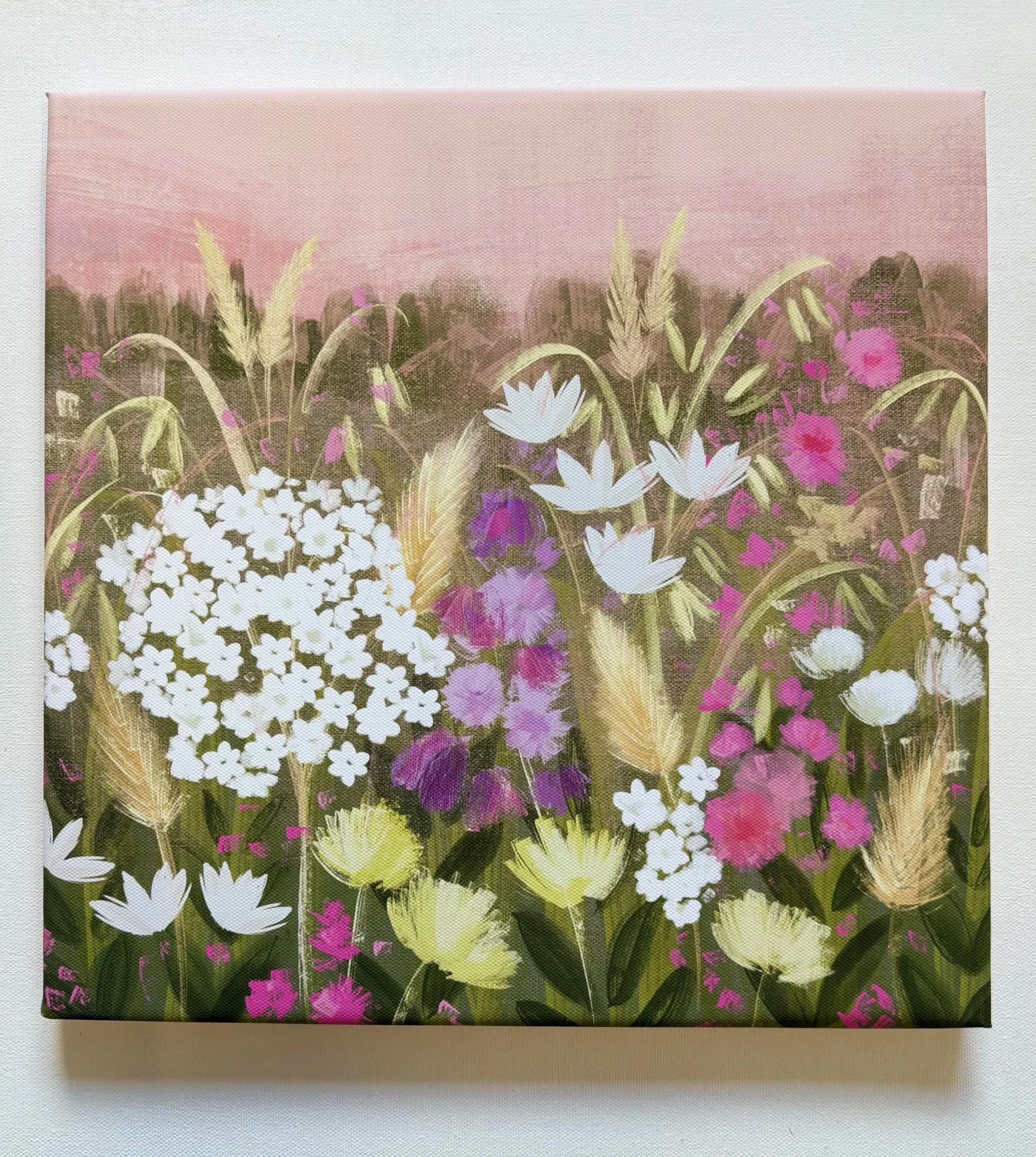 A painting of a floral landscape featuring white, pink, and purple flowers with green foliage and wheat stalks set against a pink sky.