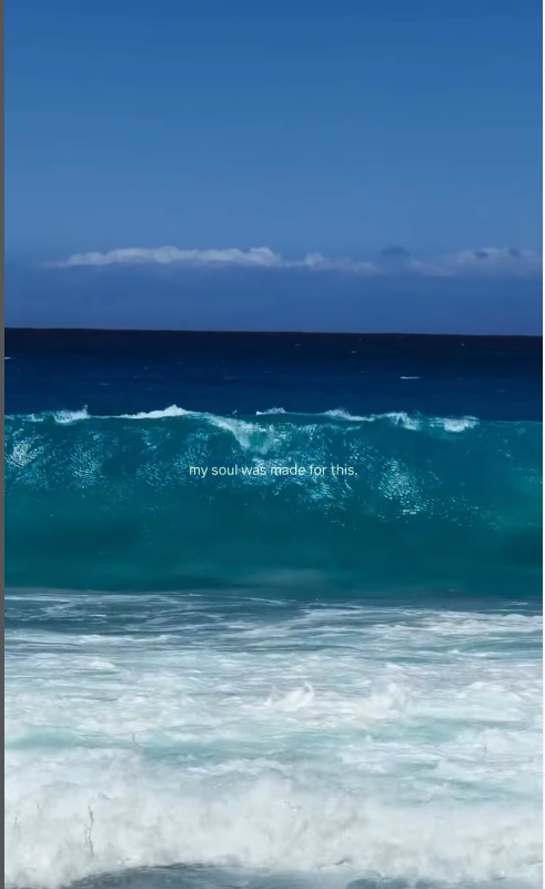 Ocean waves with a clear blue sky, 'my soul was made for this'.
