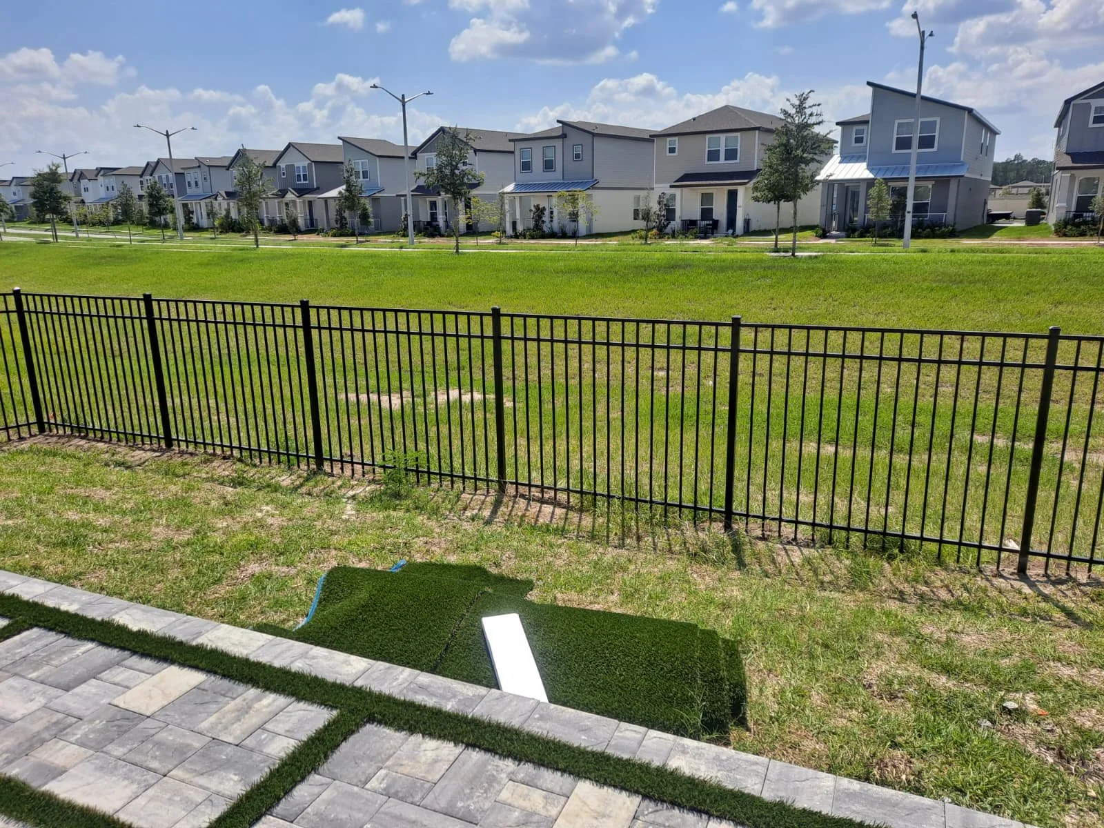Black aluminum pool fence surrounding residential community in Orlando Florida