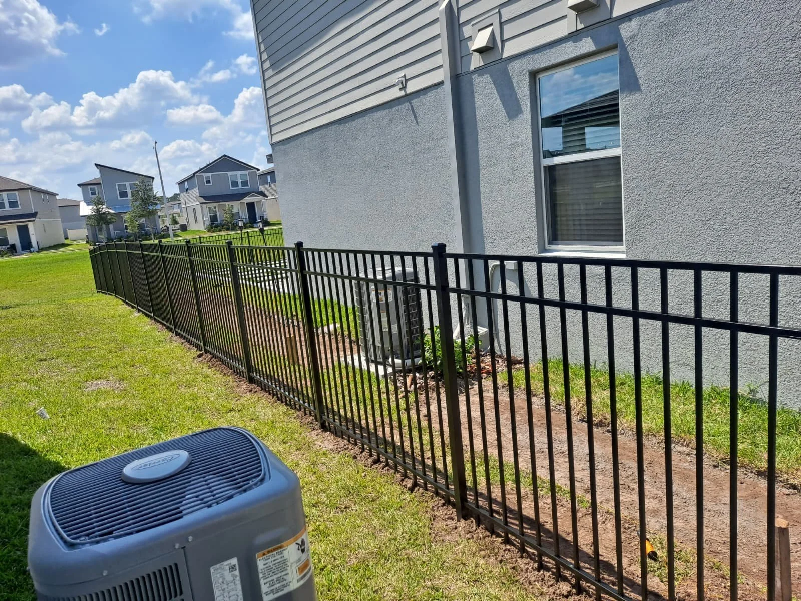 Black aluminum fence installed along residential property in Central Florida
