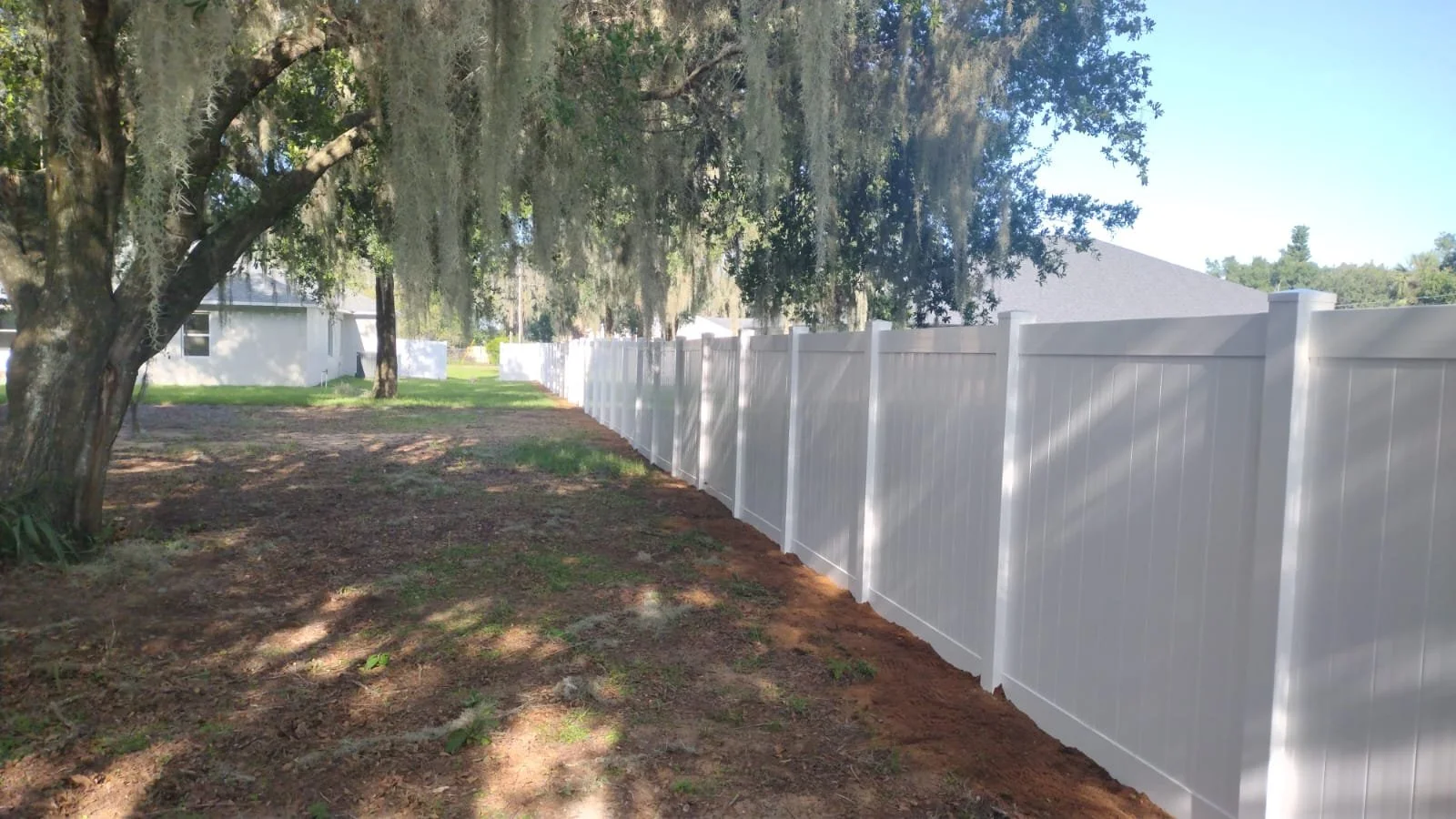 Vinyl privacy fence along shaded walkway in Orlando neighborhood