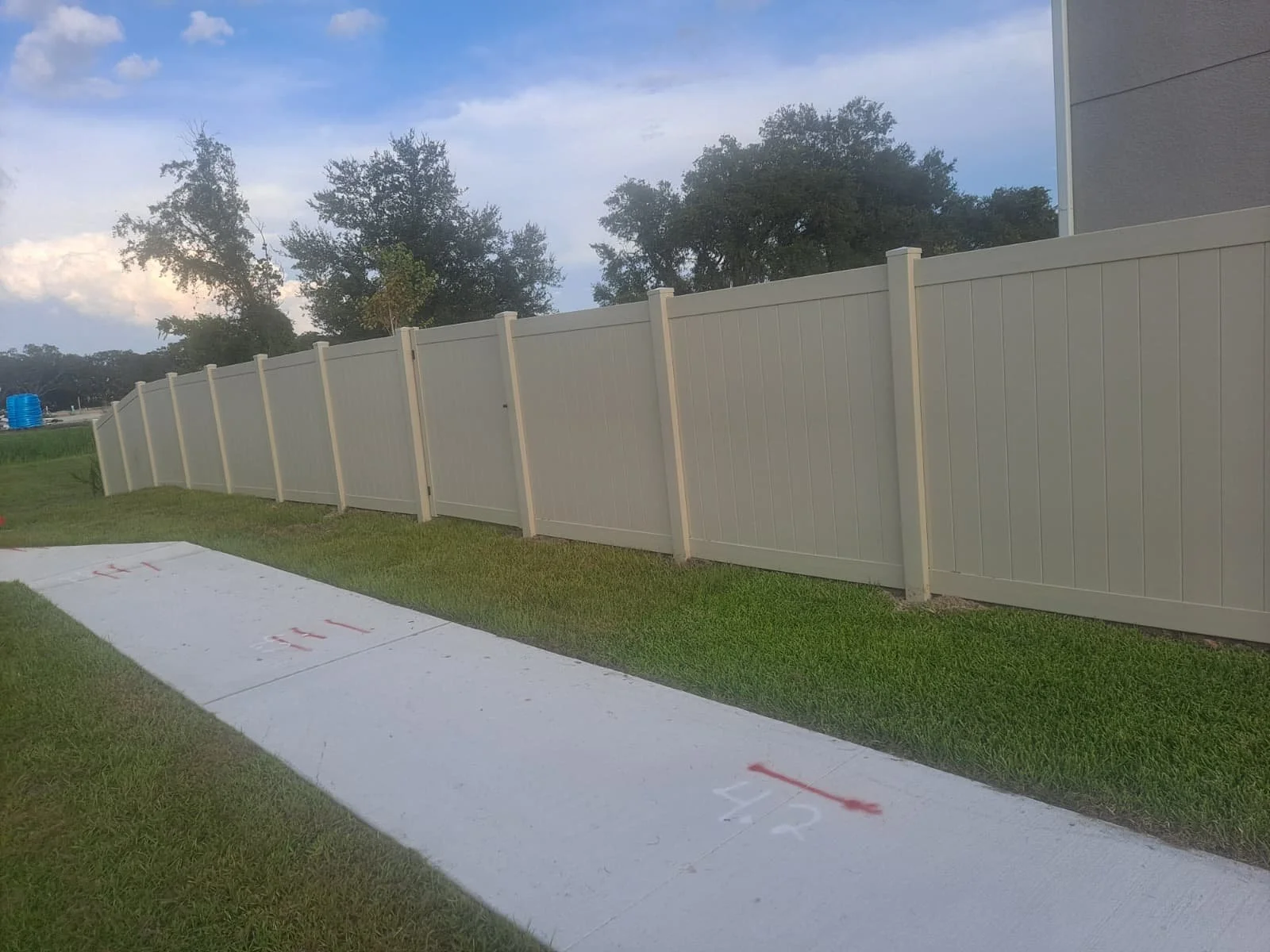 Long vinyl privacy fence installed at dusk in Central Florida backyard