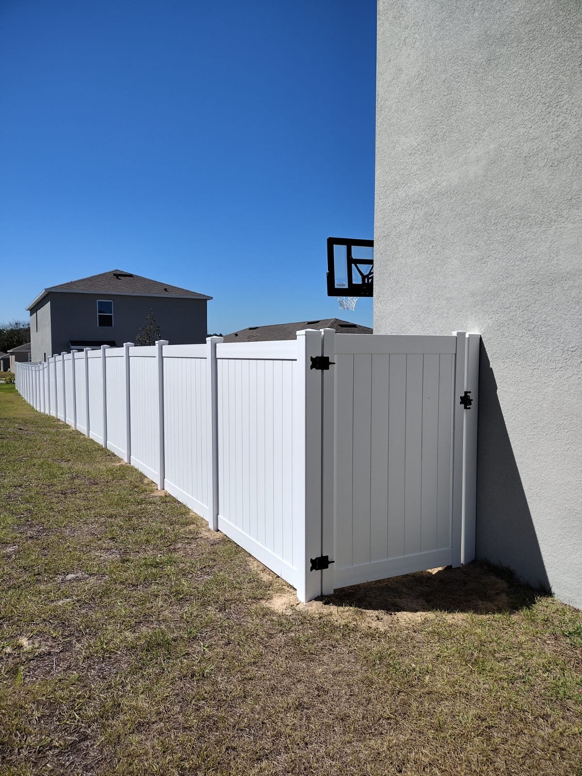 Vinyl fence installation around storage shed in Florida backyard
