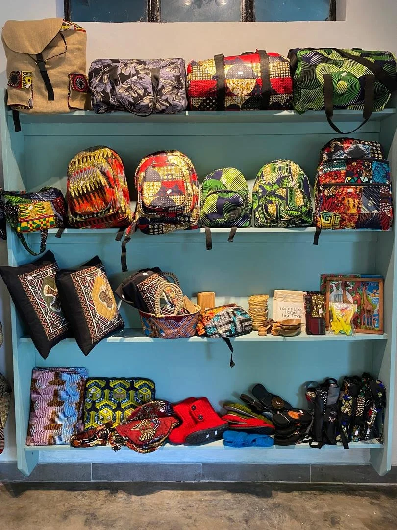 Shelves displaying various colorful bags, backpacks, and accessories.