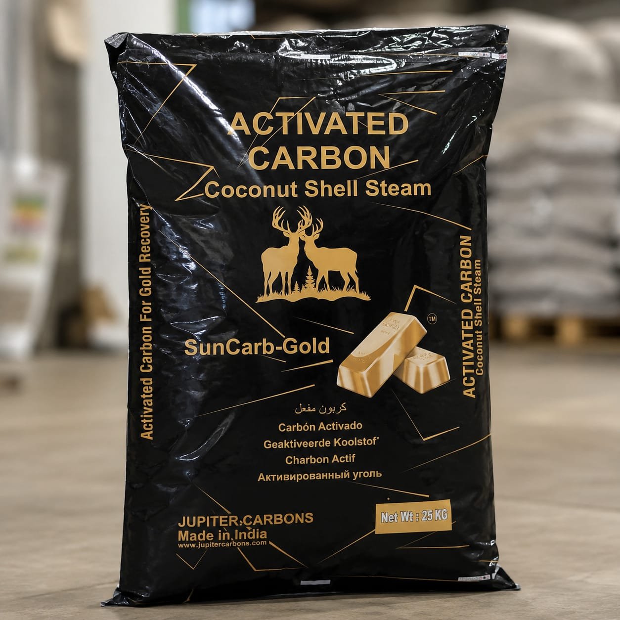 Black bag of activated coconut shell charcoal from Jupiter Carbons, featuring a gold silhouette of two deer and text indicating it's activated coconut shell steam charcoal, with small images of charcoal pieces and a Net Wt 25 KG label.