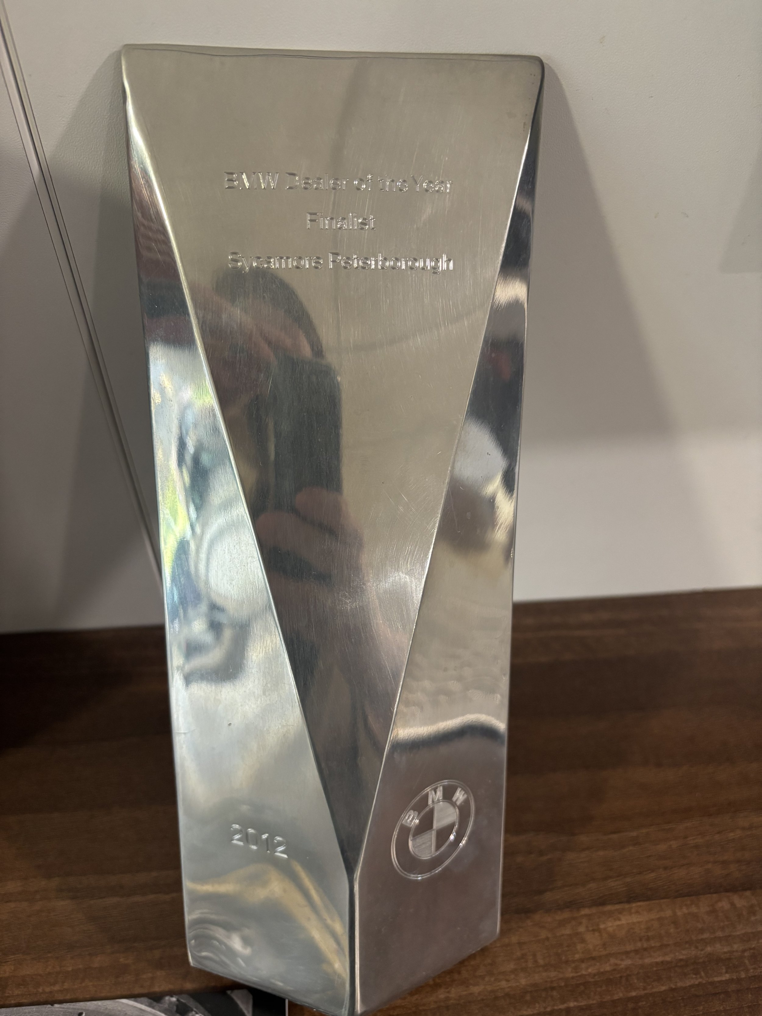 A metallic glasses trophy with the BMW logo engraved on the front, awarded in 2012, for being a finalist in a BMW dealer of the year competition in Sycamore, Peteborough.