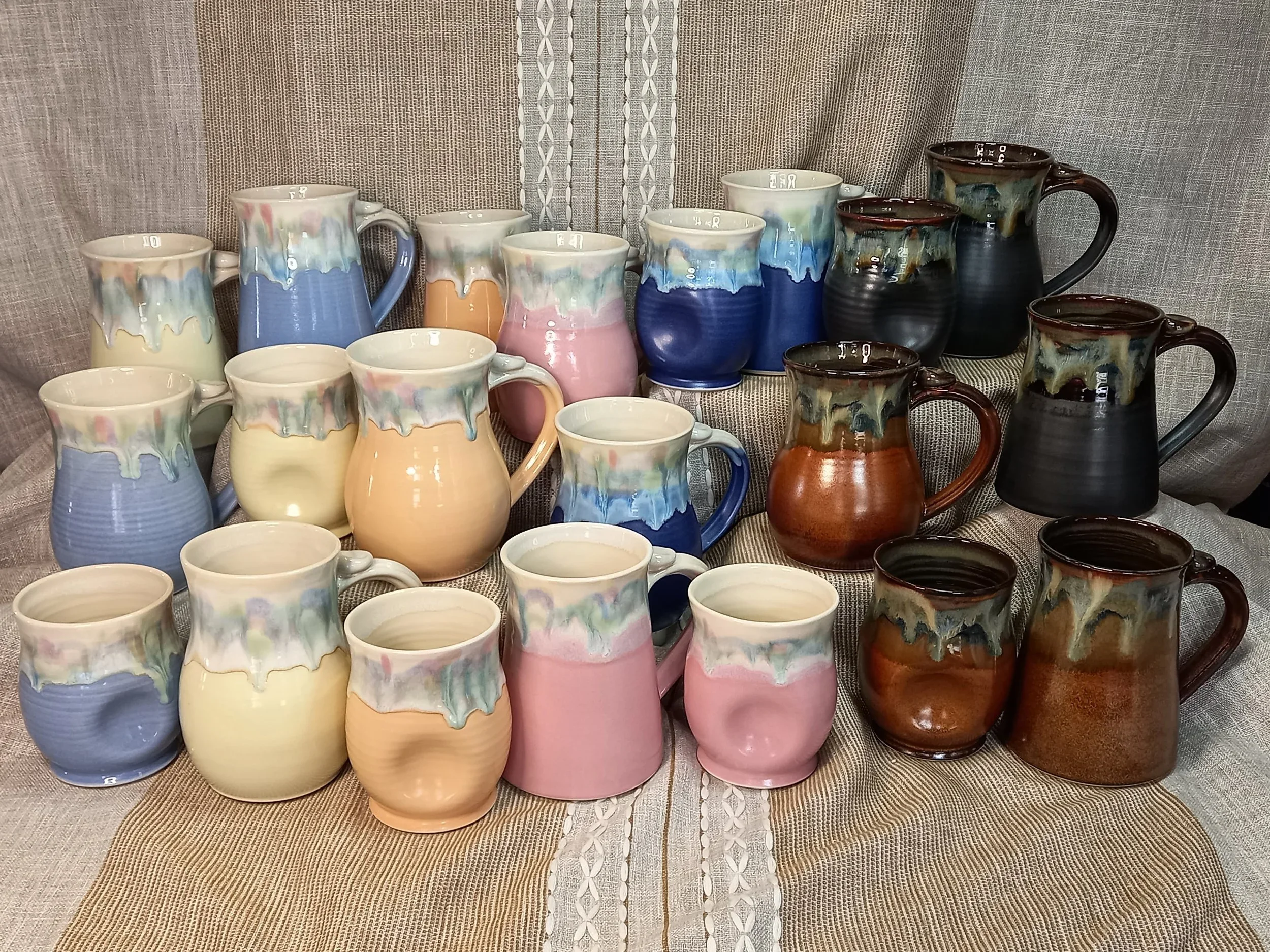 drippy pottery mugs in pink, white, peach, blue, pirple, brown and black