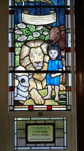 lion, lamb and deer and child stained glass