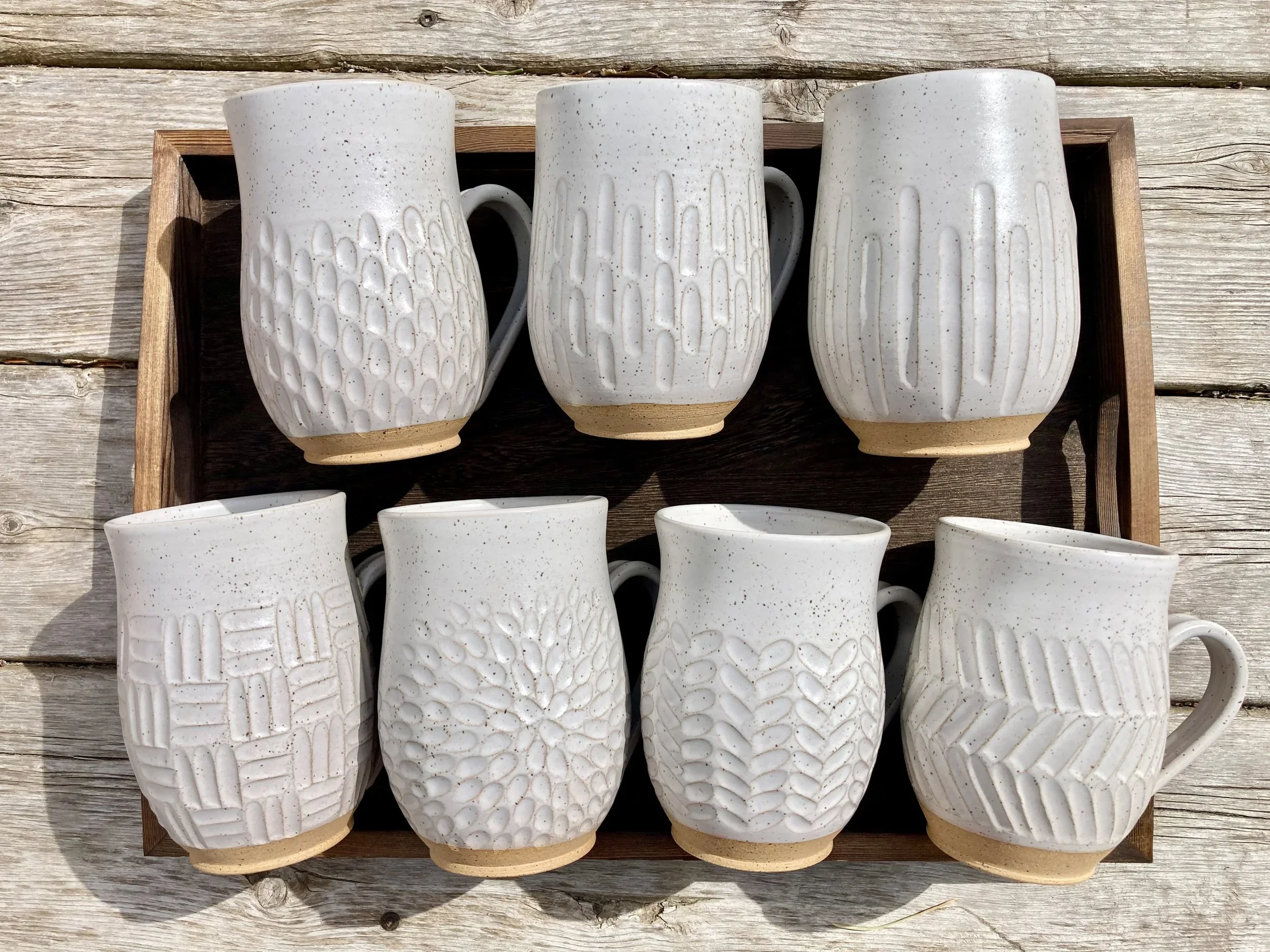 carved pottery mugs