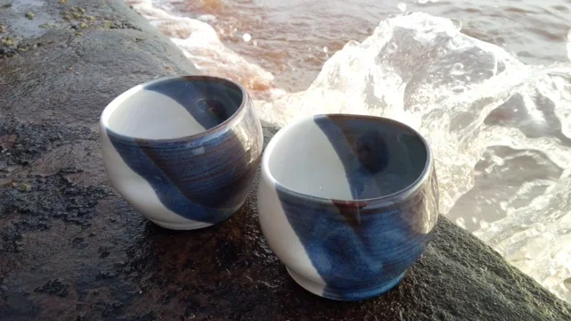 pottery cups on the shore