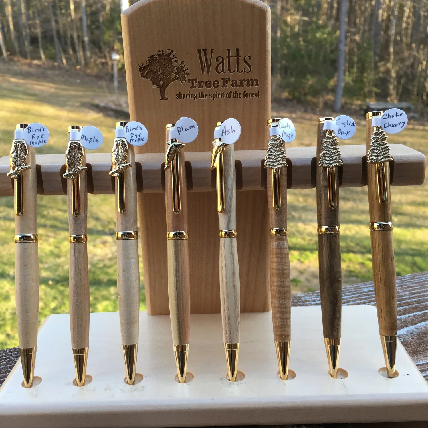 collection of wood turned pens in various woods