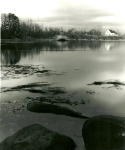 pinhole photography looking over the water at a house in the distance