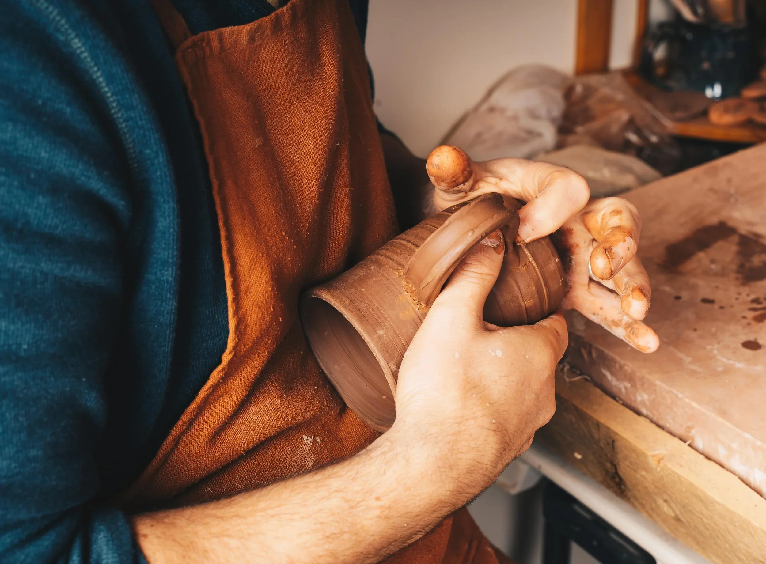 forming a handle on a pottery mug