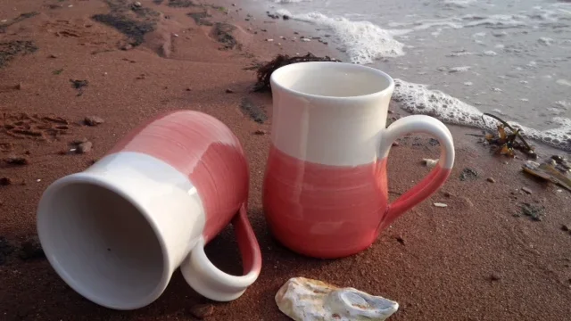 pottery mugs on the shore