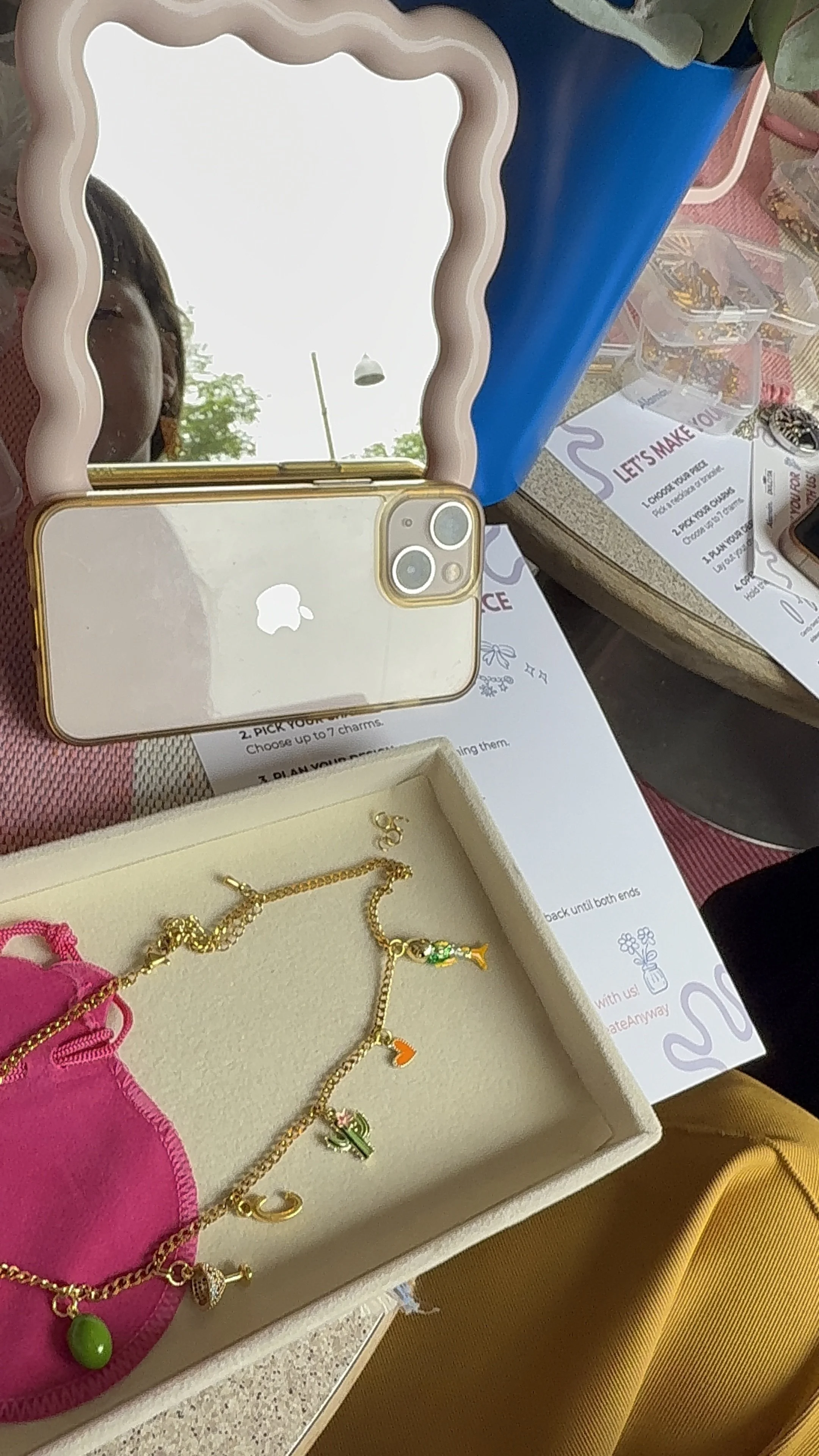 Necklace and colorful charms displayed at an Alamán workshop