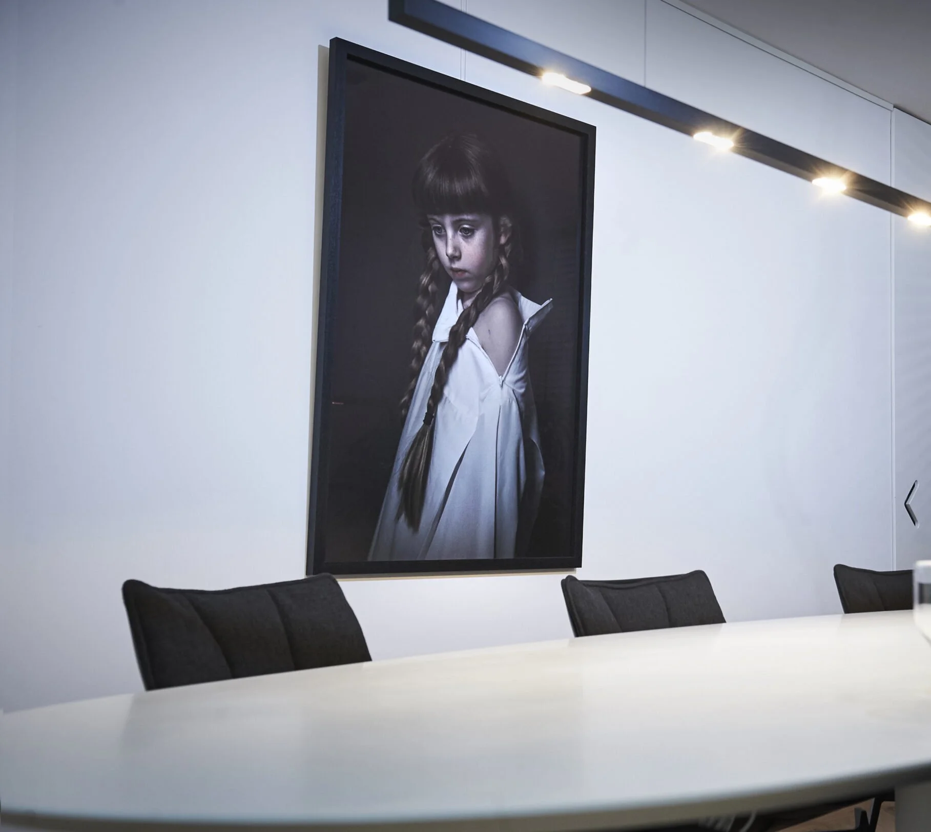 Law office meeting area with large portrait artwork and contemporary interior design in Amsterdam