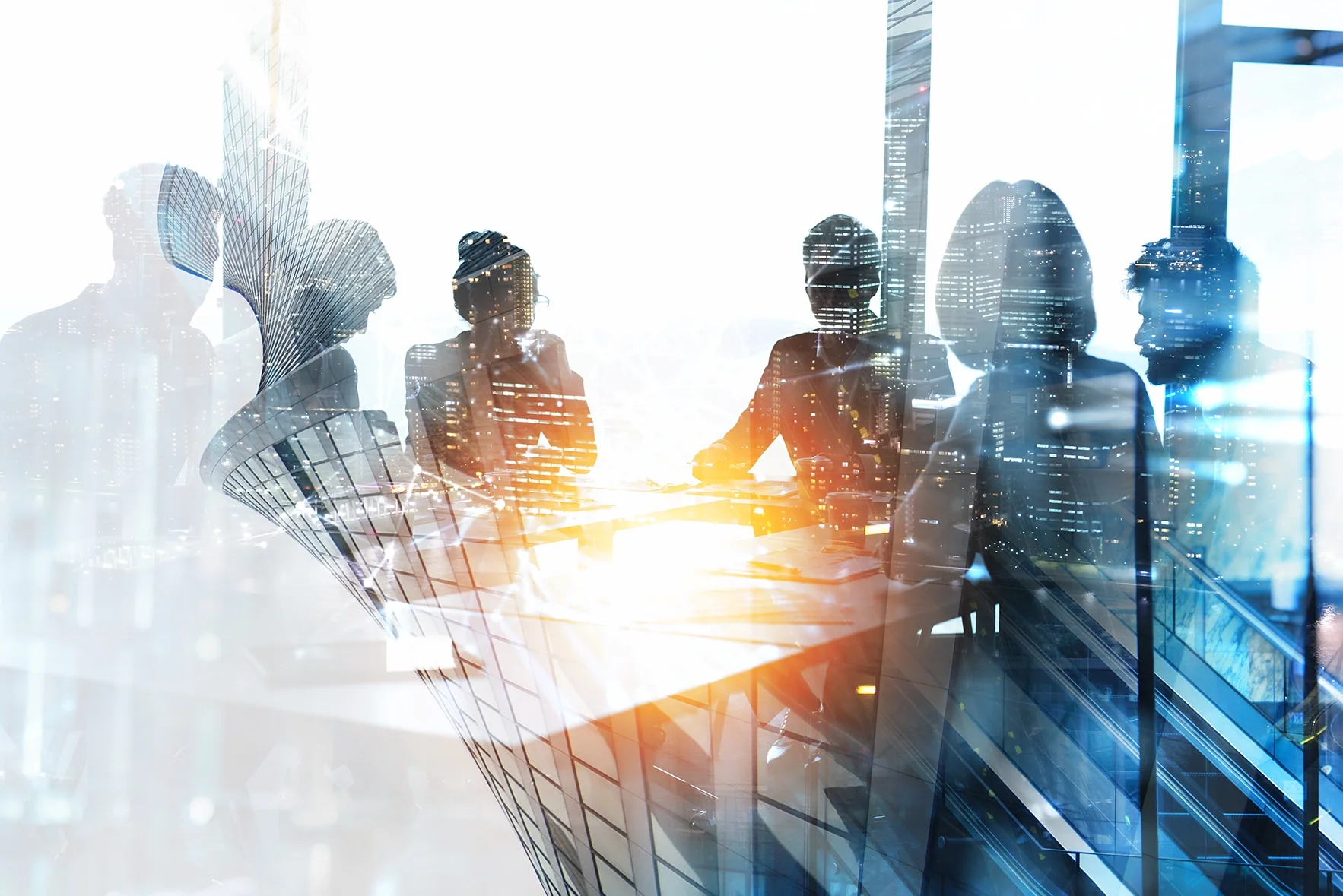 Silhouettes of five people sitting around a table in a modern office, with a city skyline and skyscrapers visible through large windows behind them.