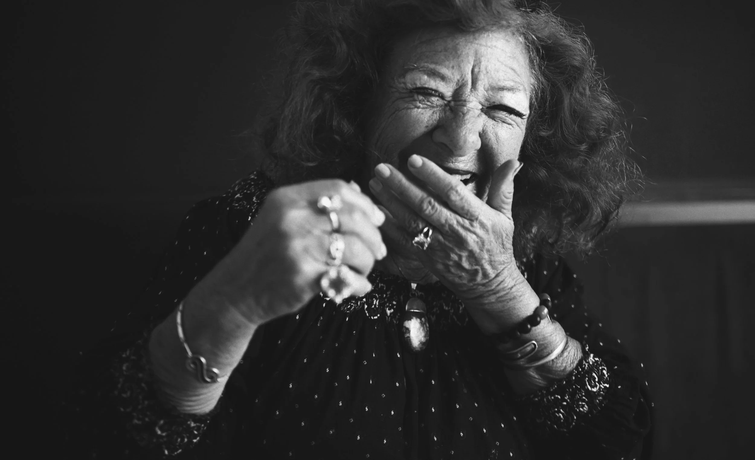Older woman laughing. Monochrome portrait expressing joy, memory and human connection.