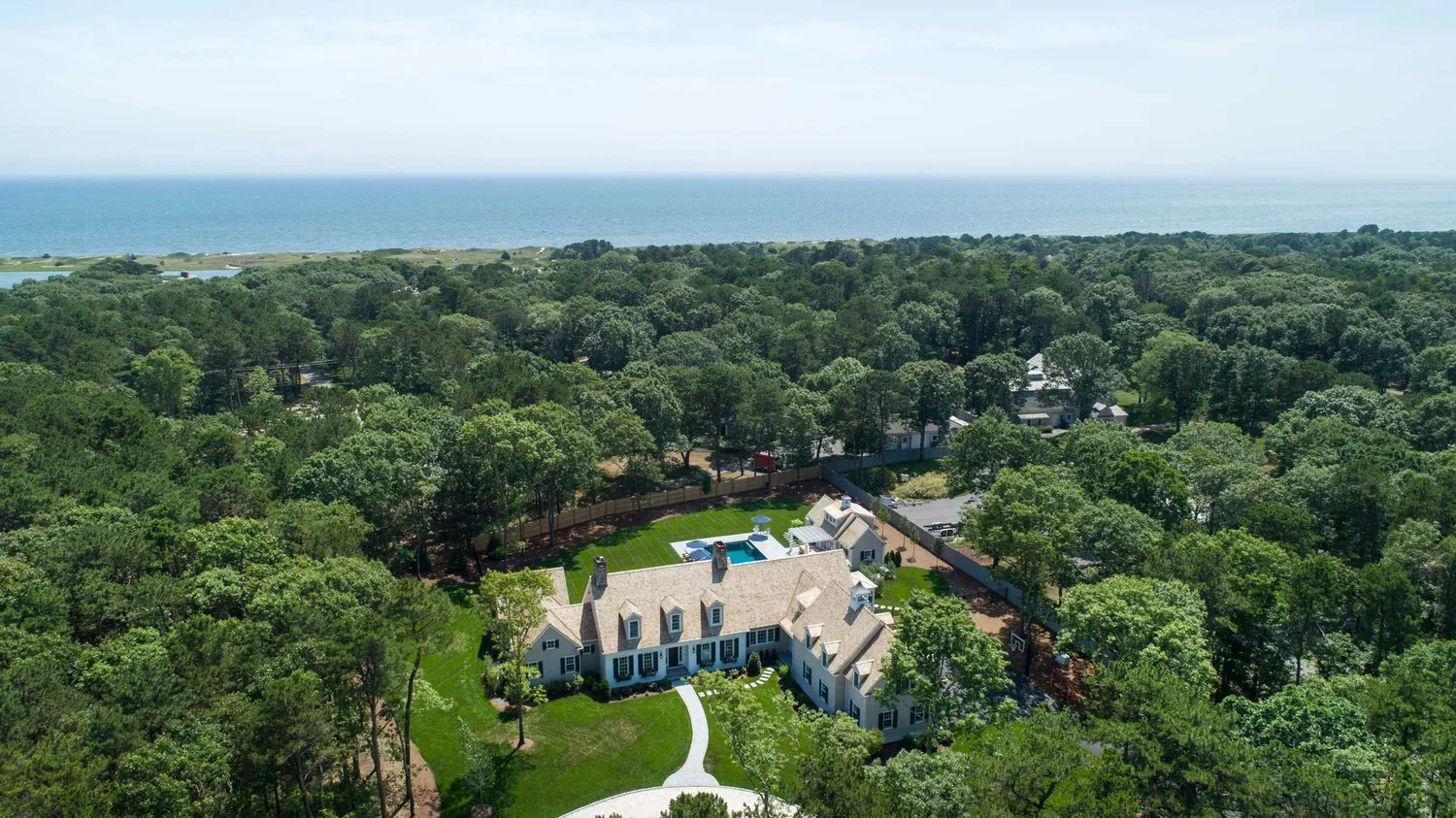 james-golden-oyster-harbors-family-compound-aerial-arrival-driveway-pool-cabana-pergola.webp