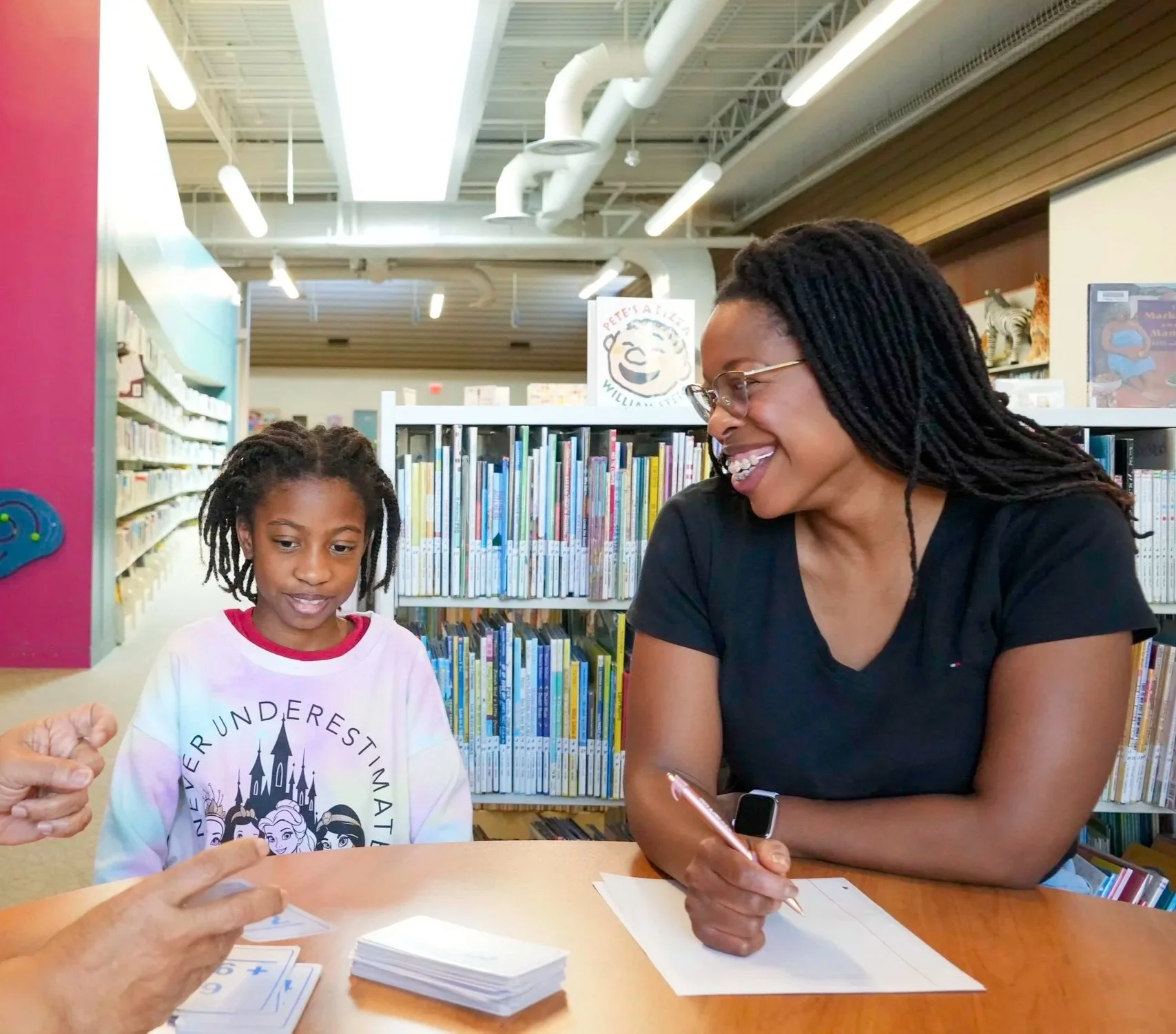 parent and child having a meeting with tutor looking at what they can do to improve behavior and education black mom and black daughter all are welcome