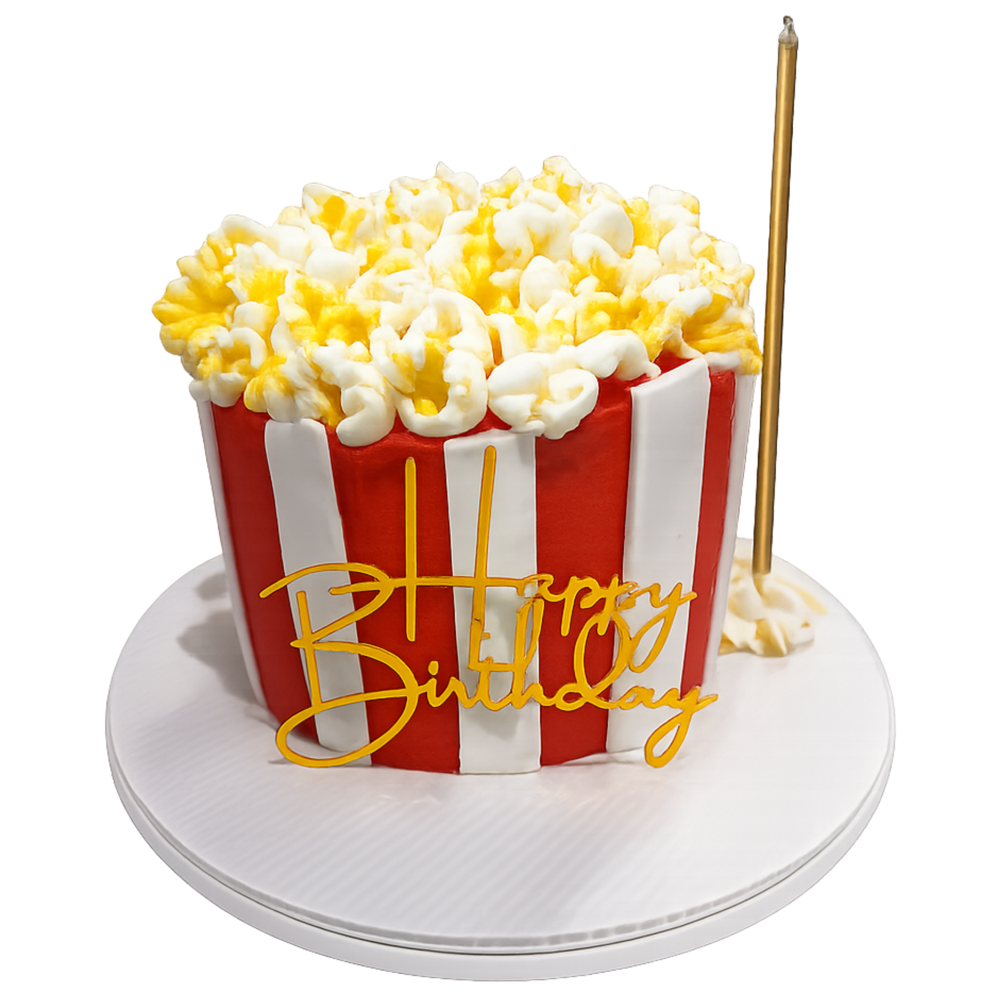 A birthday cake designed to look like a large bucket of popcorn with white and yellow popcorn pieces on top, red and white striped pattern on the sides, and the words "Happy Birthday" written in yellow icing.