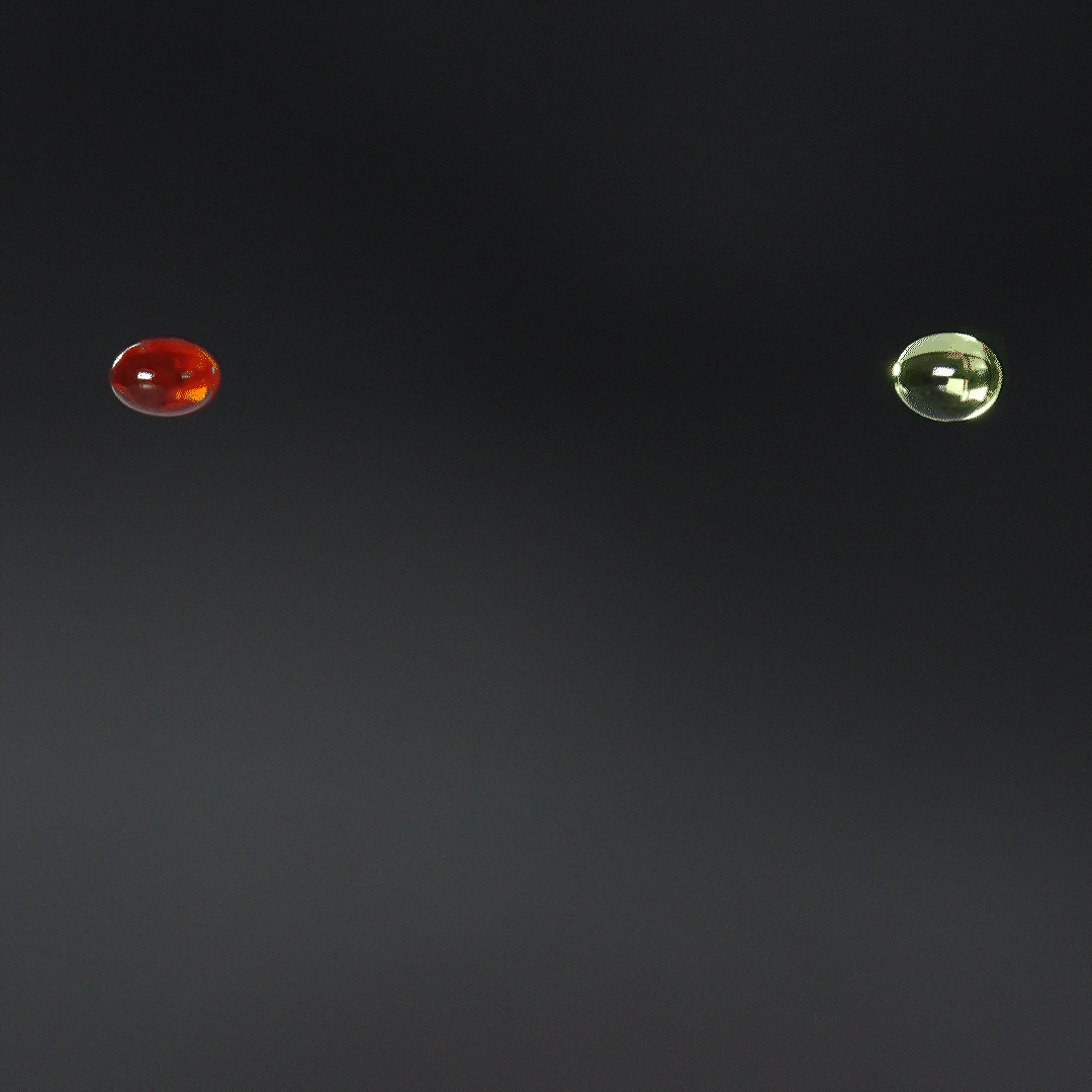 Two drops of liquid, one red and one green, falling against a dark background.