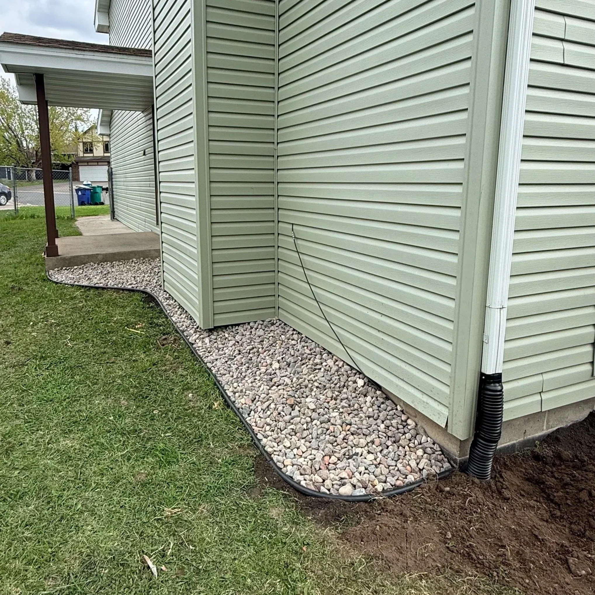 Side view of a house with newly designed and installed bed rocks. 