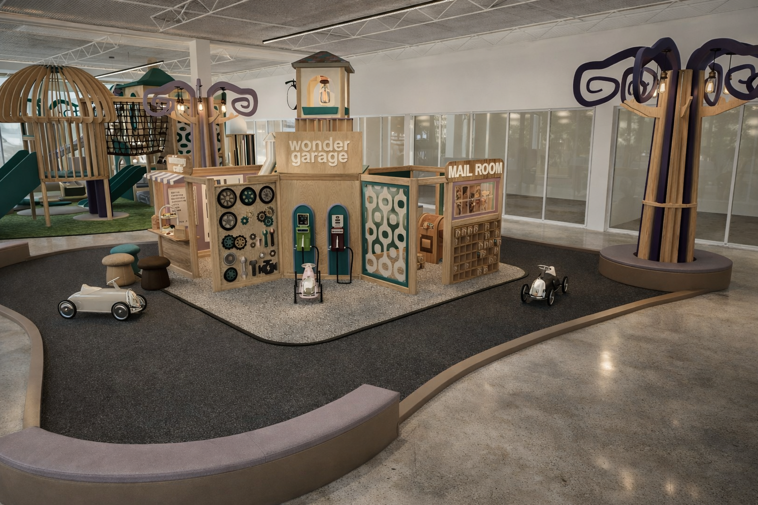 Indoor children's play area with a wooden pretend garage, mail room, and mechanical station, surrounded by modular play structures and a rubberized safety surface.