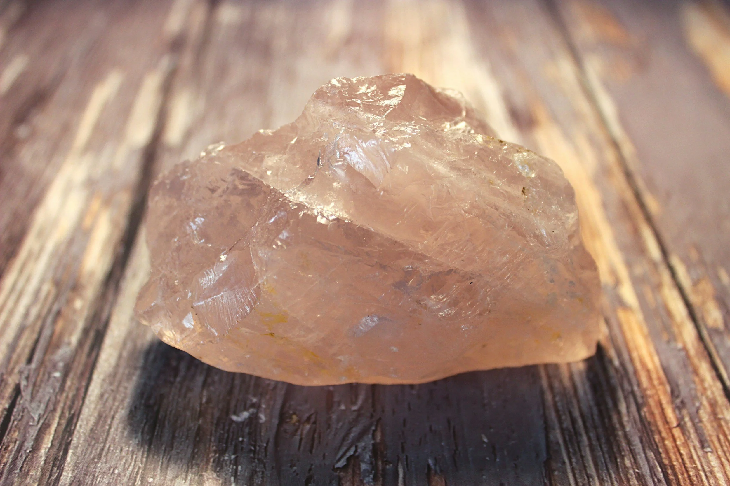 roze quarts crystal on a wooden table perfect support for sensitive expats