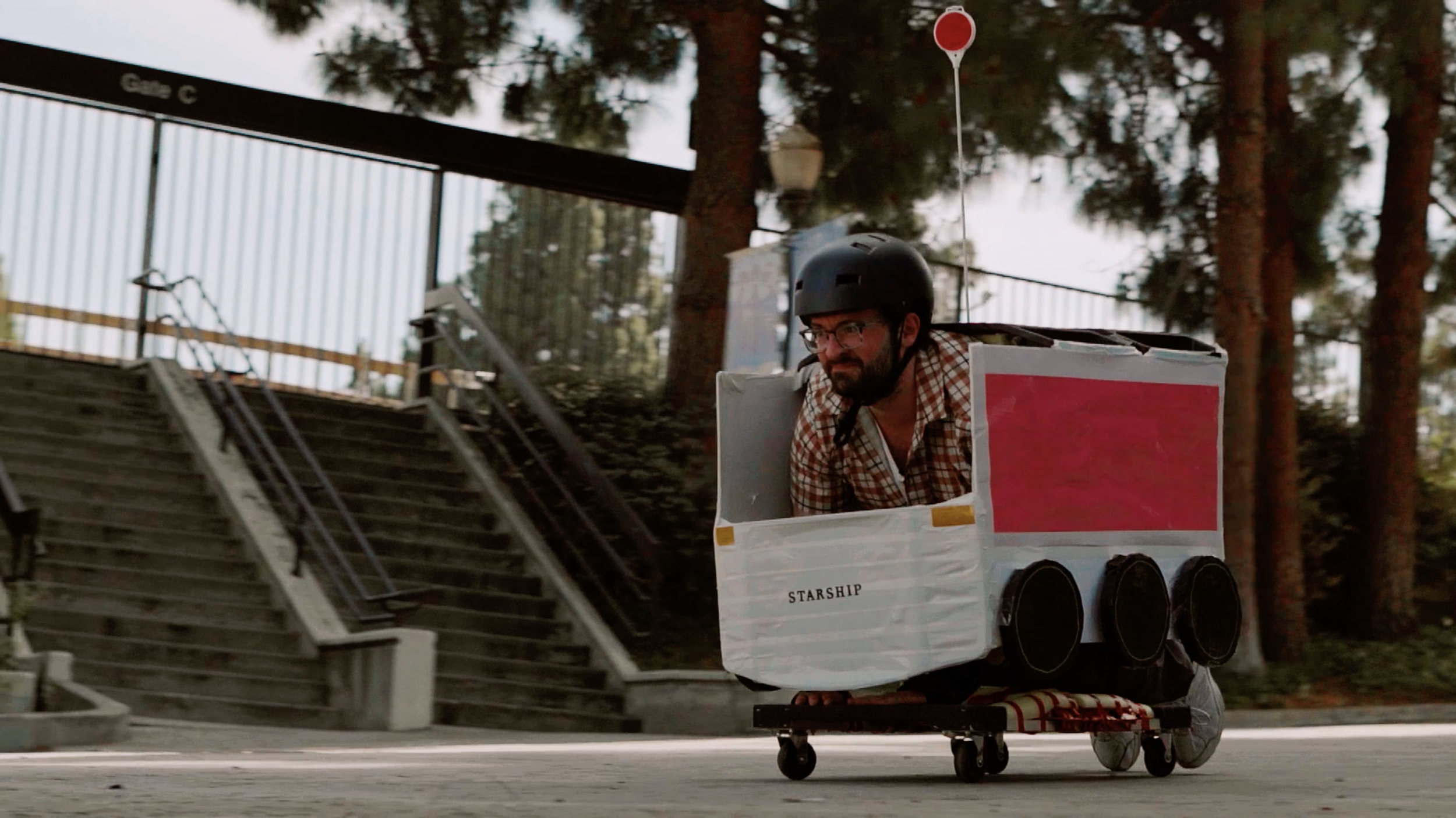 A man dressed as a Starship robot hurdles down a hill.