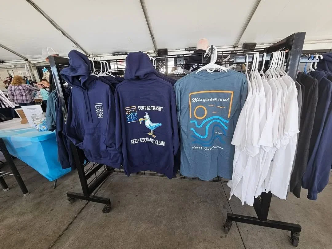 Misquamicut Beach Foundation apparel and merchandise display featuring sweatshirts and T-shirts at the Artisan Market at The Andrea.