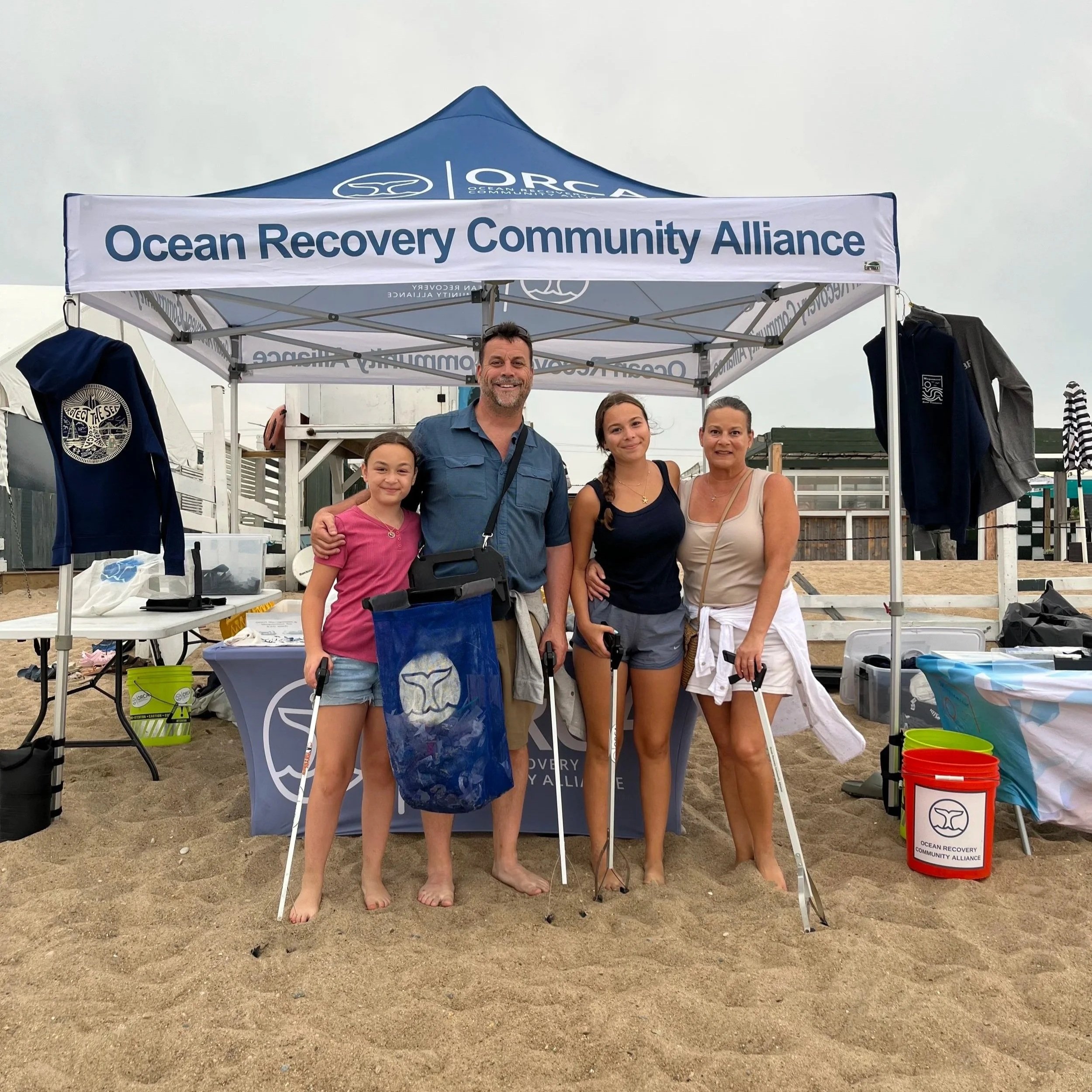ORCA volunteers standing at a beach outreach tent in Misquamicut, Rhode Island