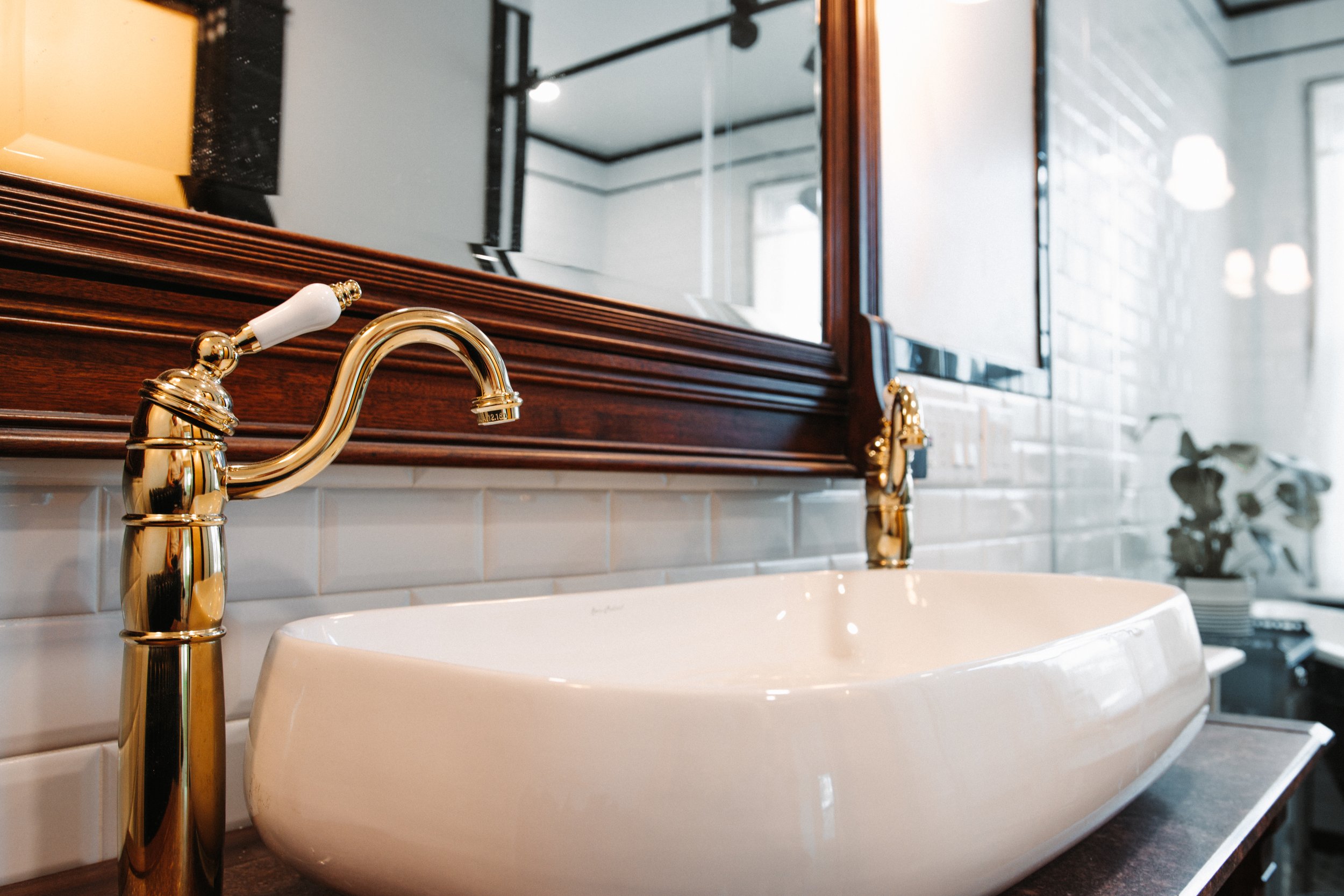Gold and White Sink 
Elegant Bathroom 
Modern Bathroom 
Construction 
Modern Design 
Kansas Construction 
Design and Construction 