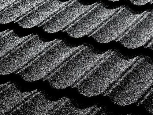 Close-up of textured, dark gray, ribbed roofing tiles.