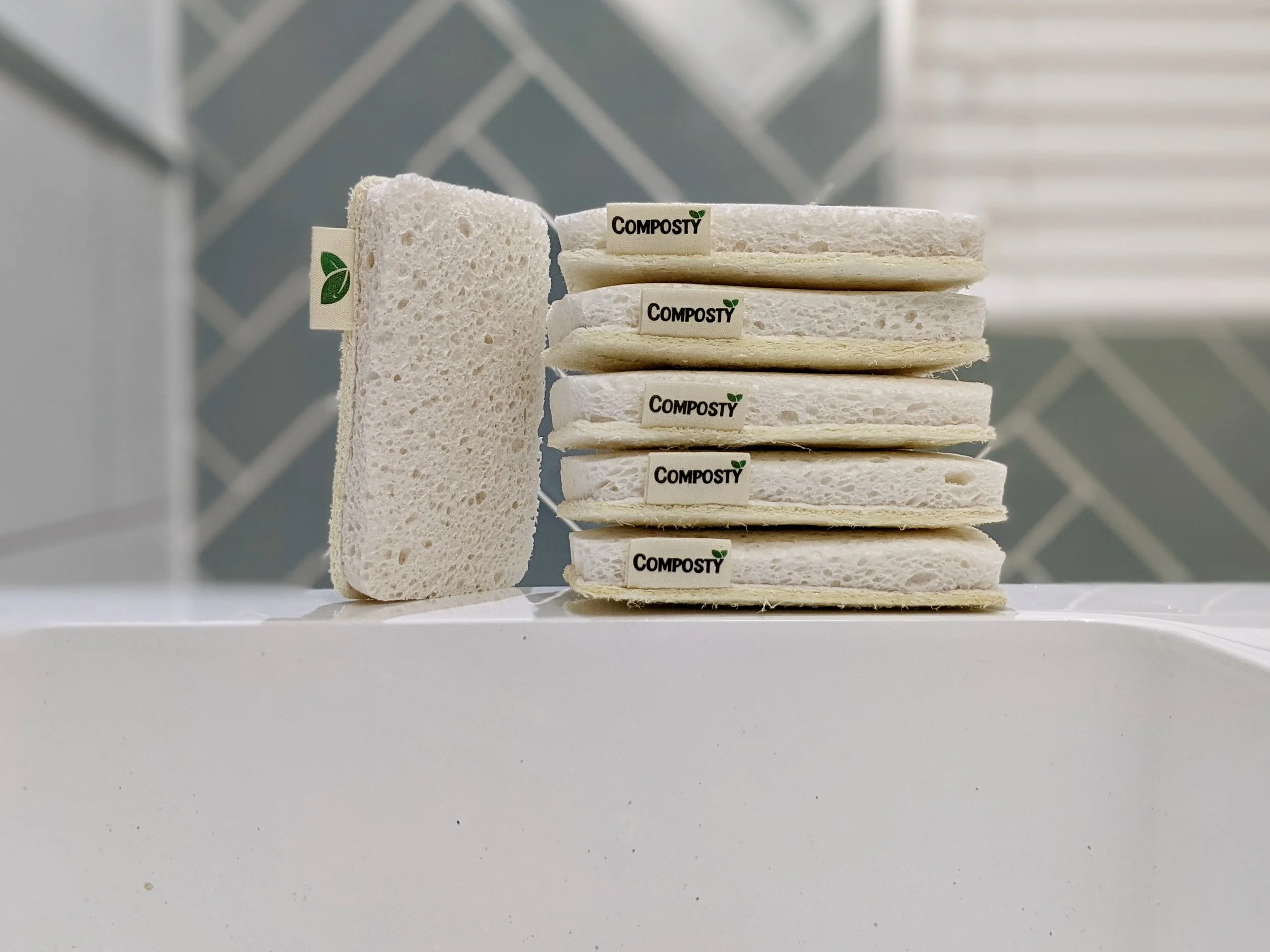 Composty eco cleaning range campaign lookbook featuring compostable pop up sponges and brand exhibition stand