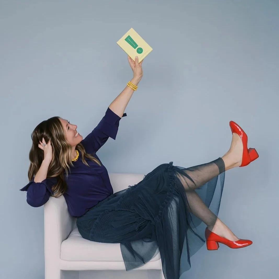 A woman holding up an exclamation point and is happy
