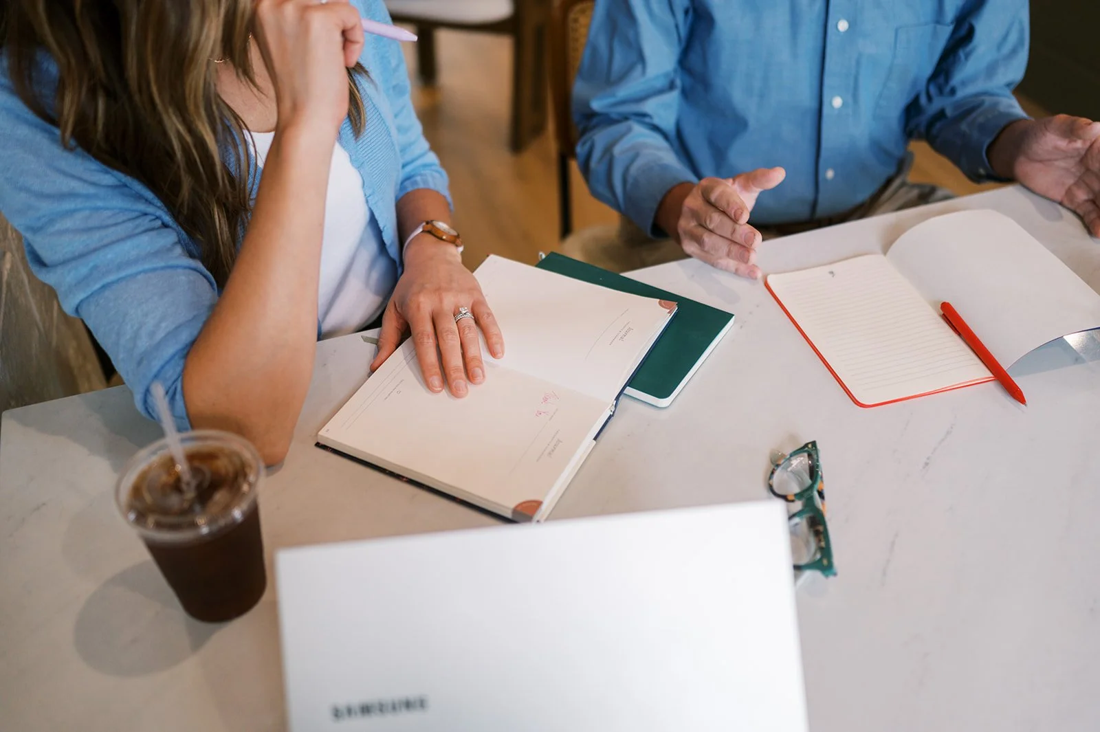 Two people at a coffee shop discussing strategy
