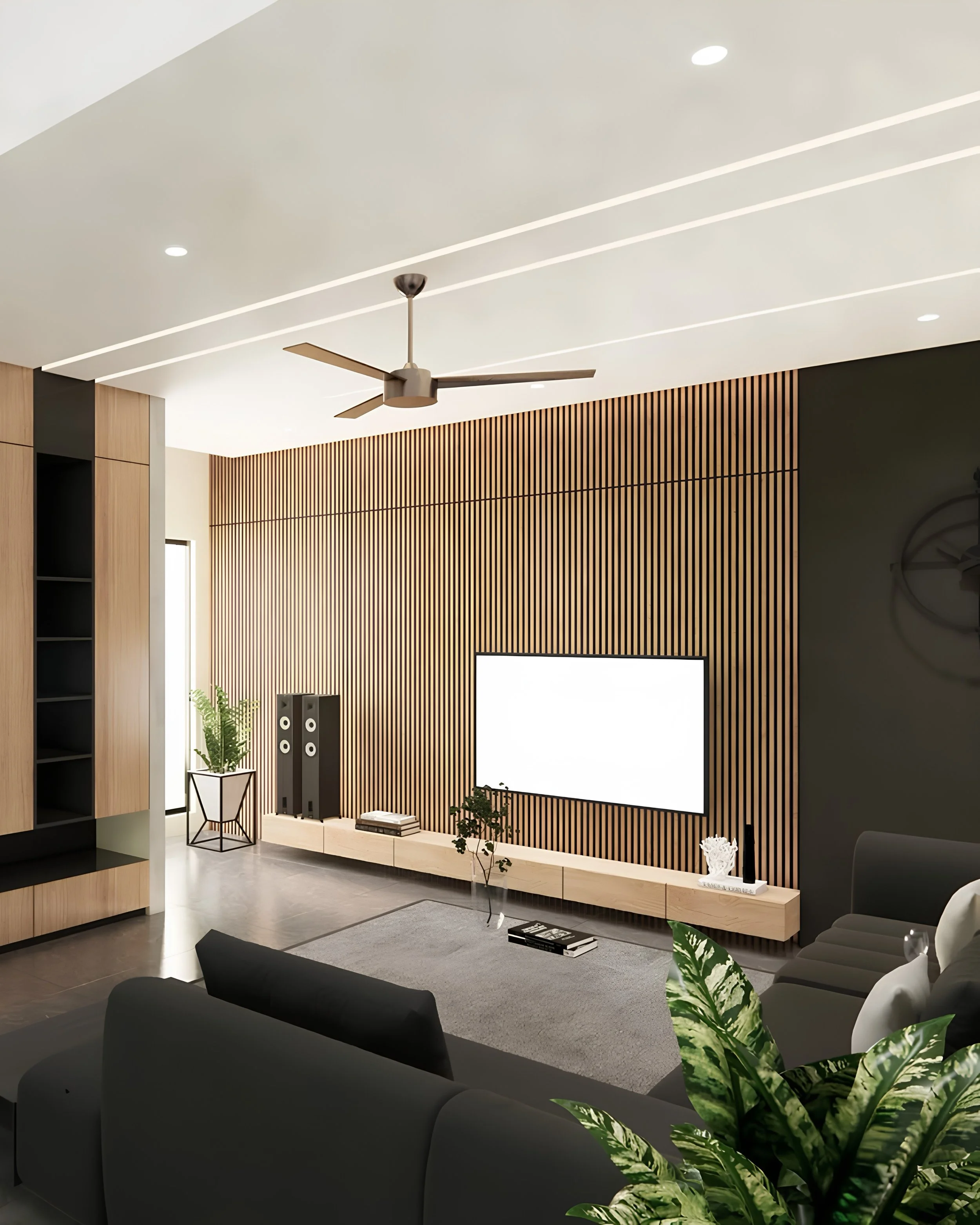 Modern living room with a large projection screen, wood paneling, a ceiling fan, potted plants, and black sofas.