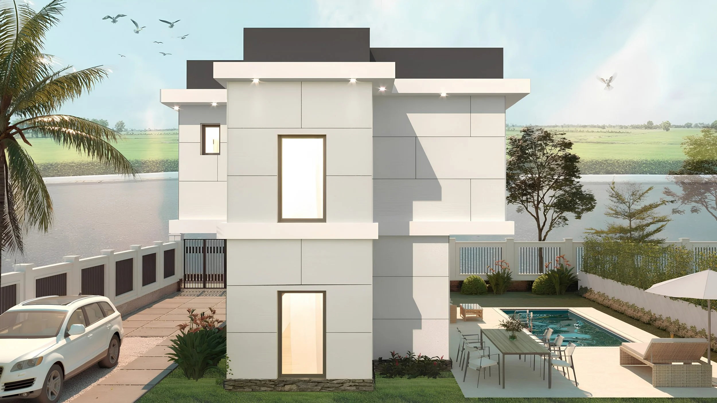 Modern white multi-story house with a flat roof, tall narrow windows, overlooking a backyard with a swimming pool, poolside seating, and a patio, surrounded by a white fence, with some trees, a water body, and a field in the background, under a partl