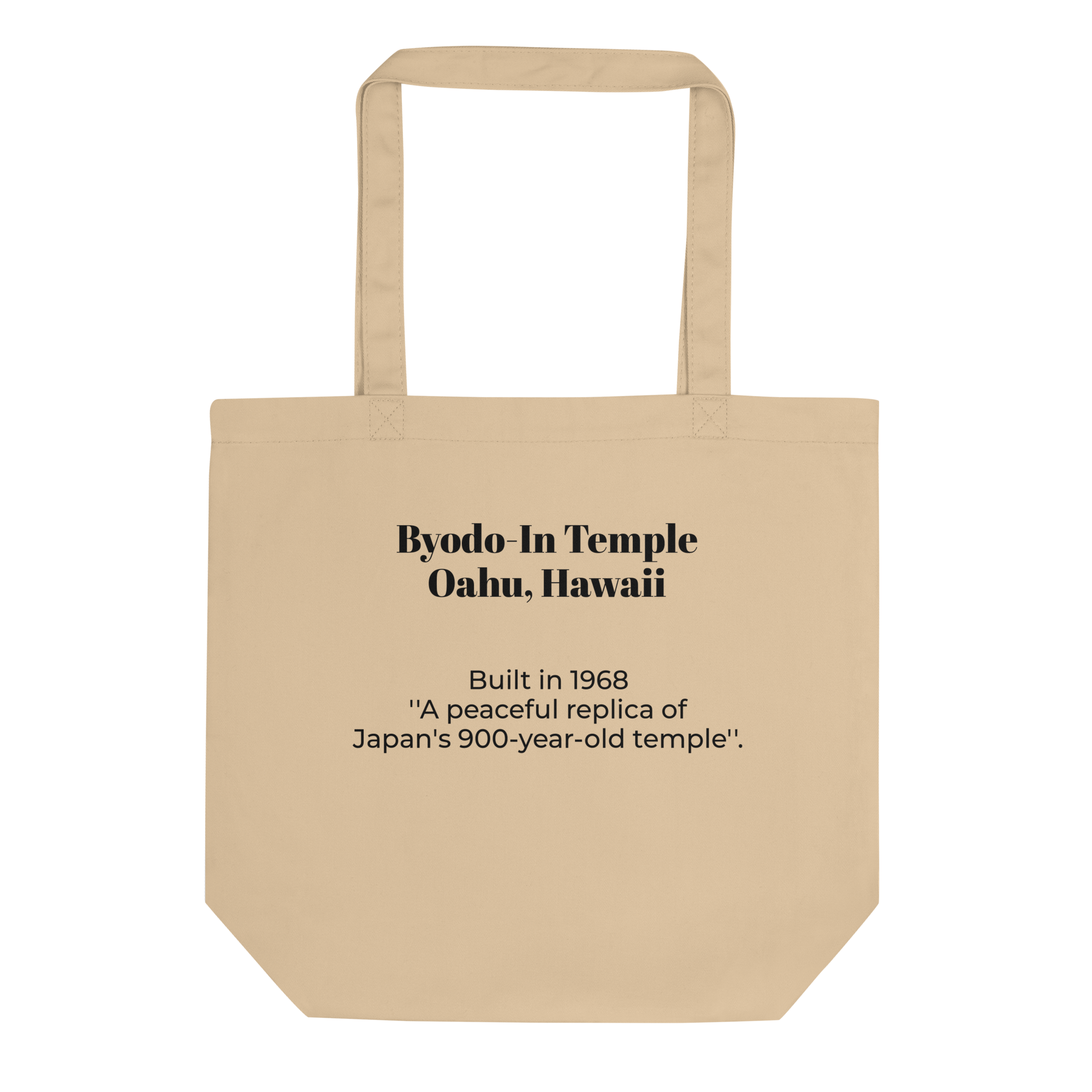 Beige tote bag with black text that reads "Byodo-In Temple Oahu, Hawaii" and additional text about its history.