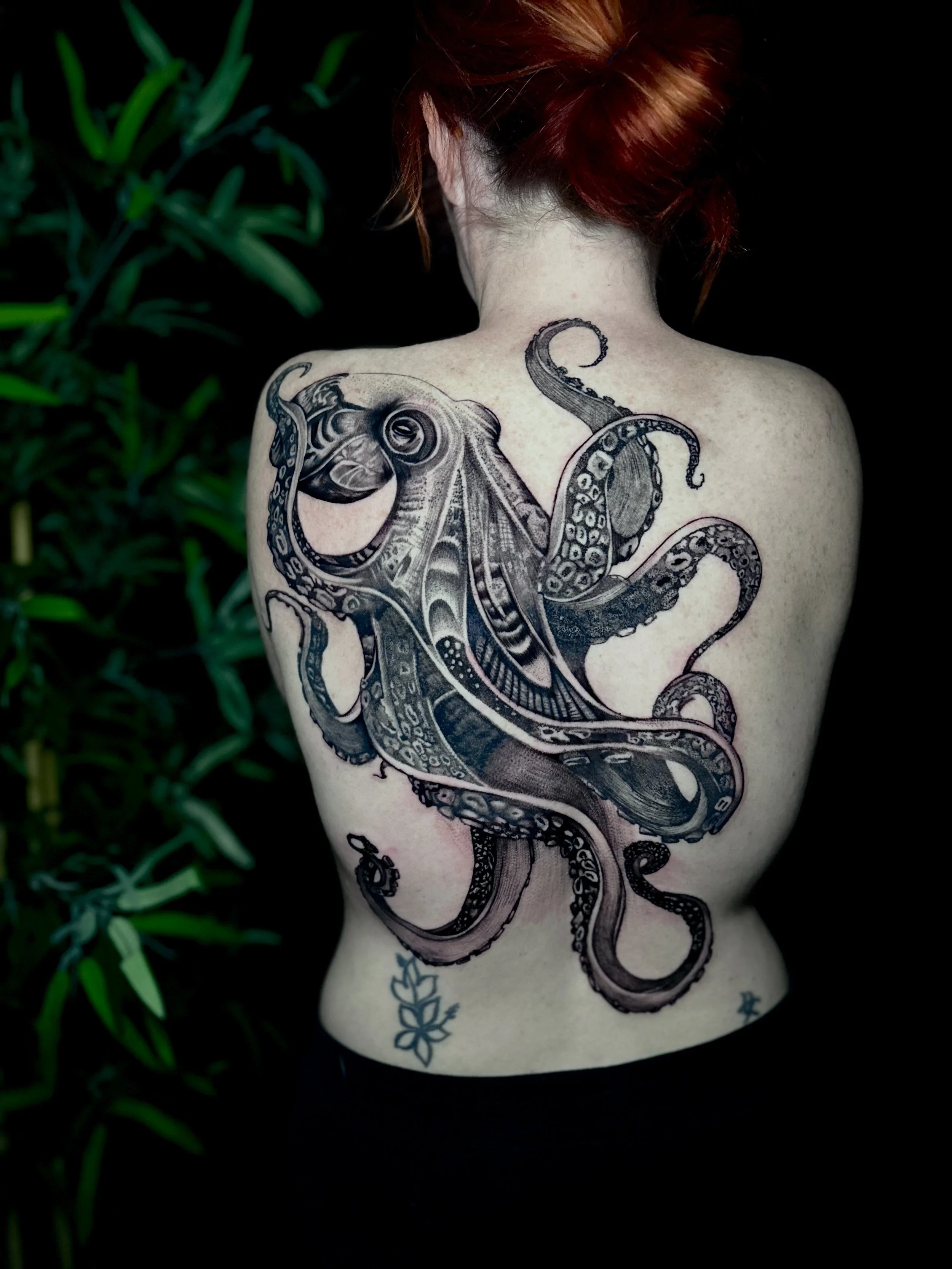 illustrative realism octopus back piece tattoo