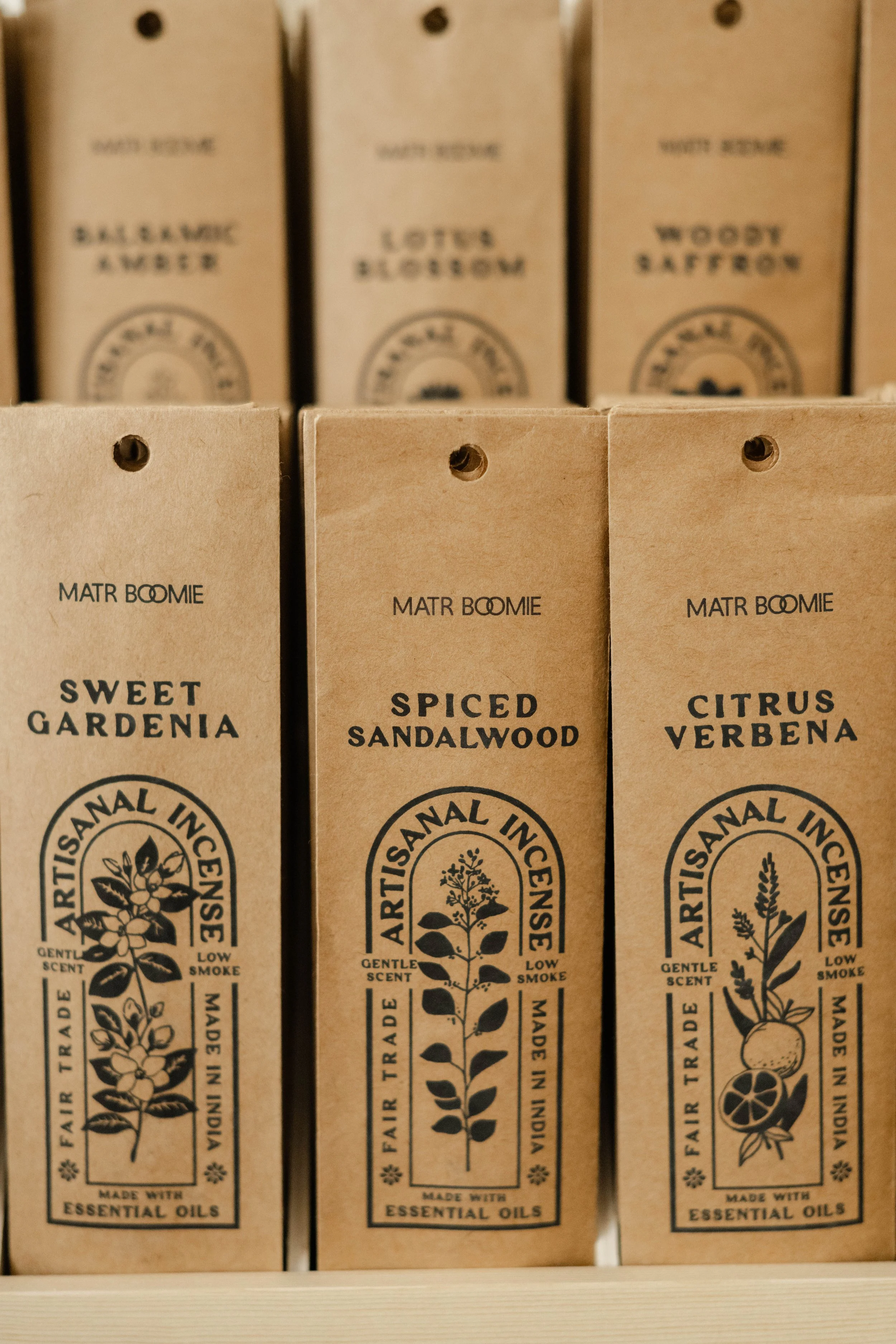 Shelf with three boxes of aromatic essential oils, labeled 'Sweet Gardenia,' 'Spiced Sandalwood,' and 'Citrus Verbena.'