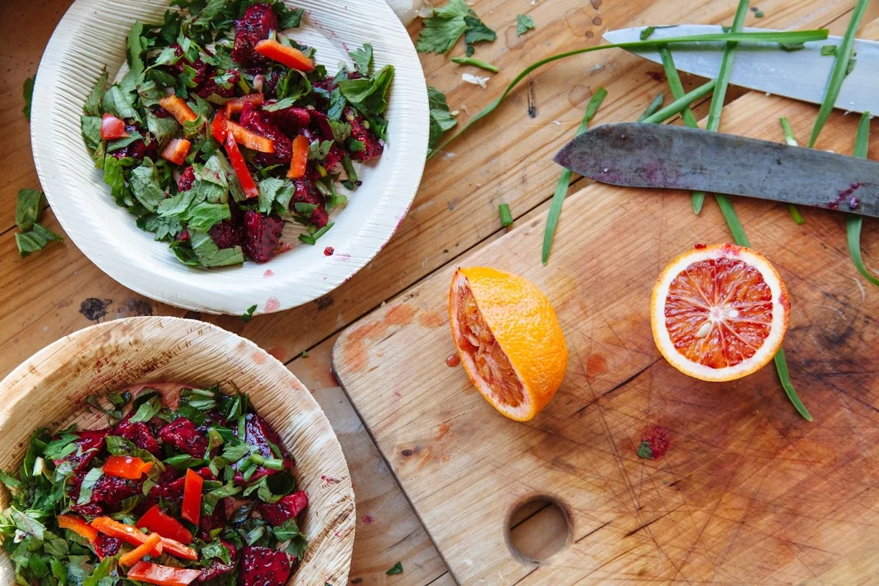 Fresh salad ingredients and healthy meal preparation on a wooden cutting board
