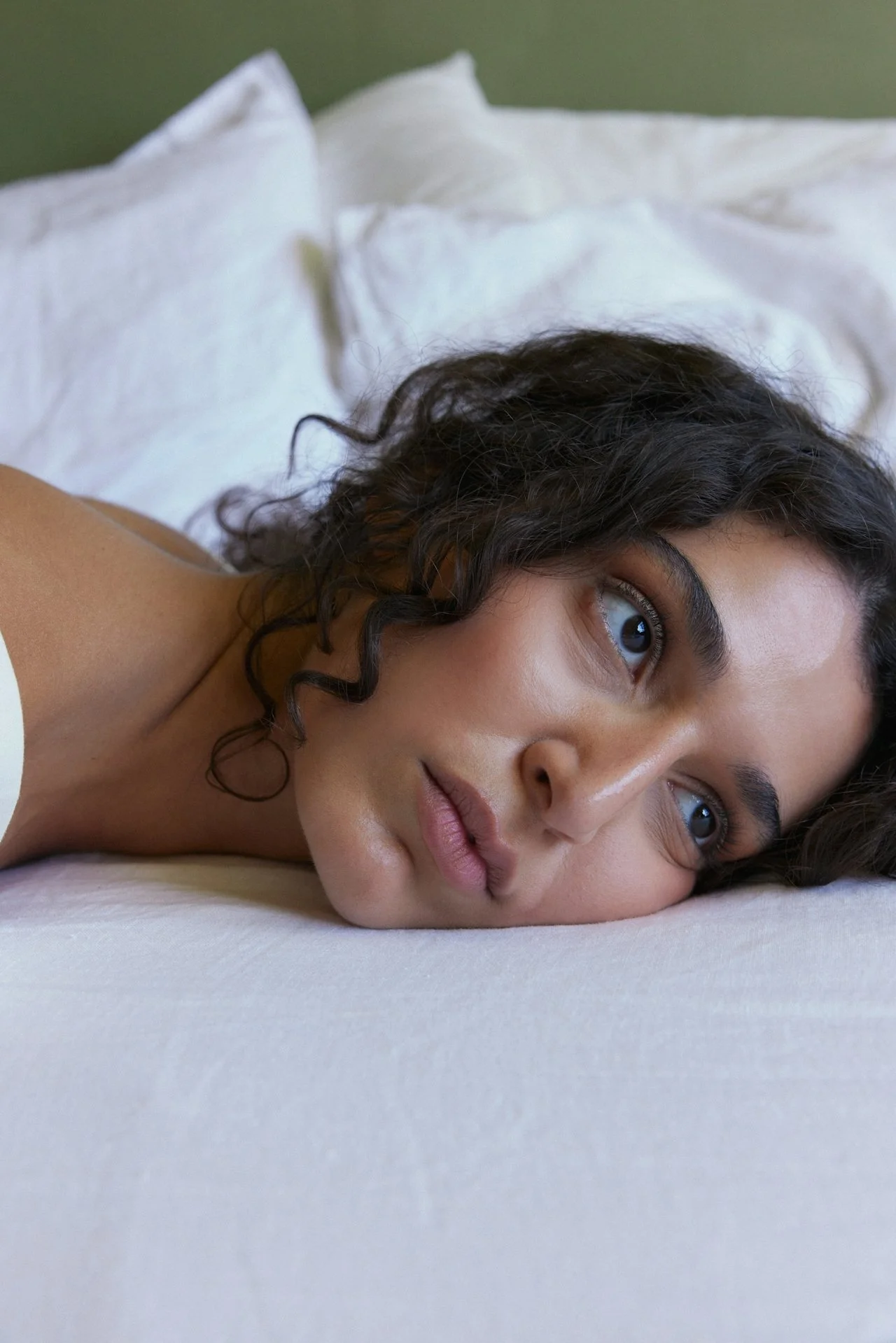 Woman lying awake in bed experiencing difficulty sleeping