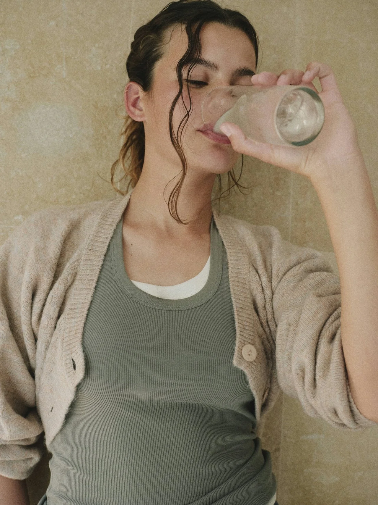 Woman drinking water and supporting healthy lifestyle habits