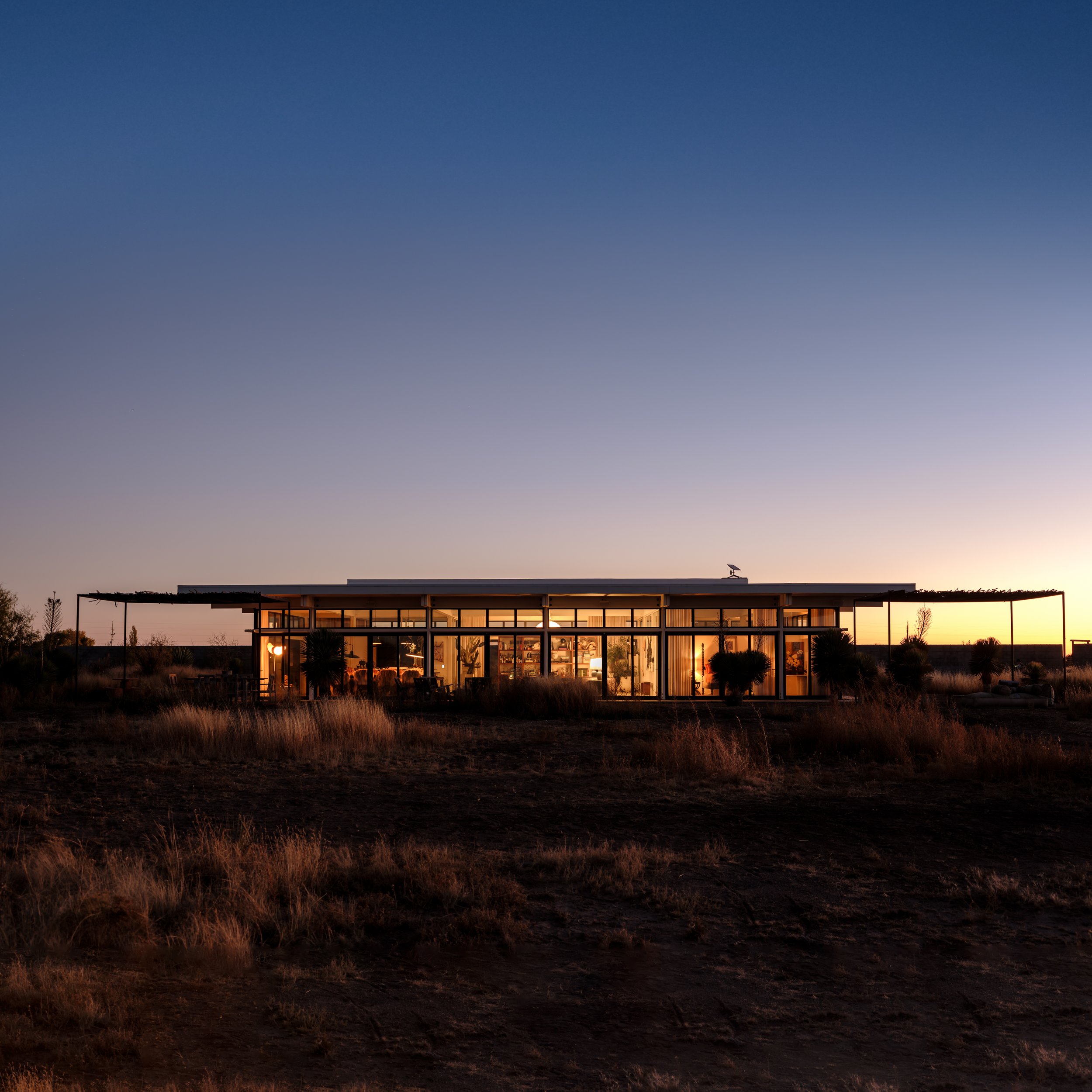 Twilight exterior photograph of Friedman Ranch in Marfa with modern desert architecture at dusk.