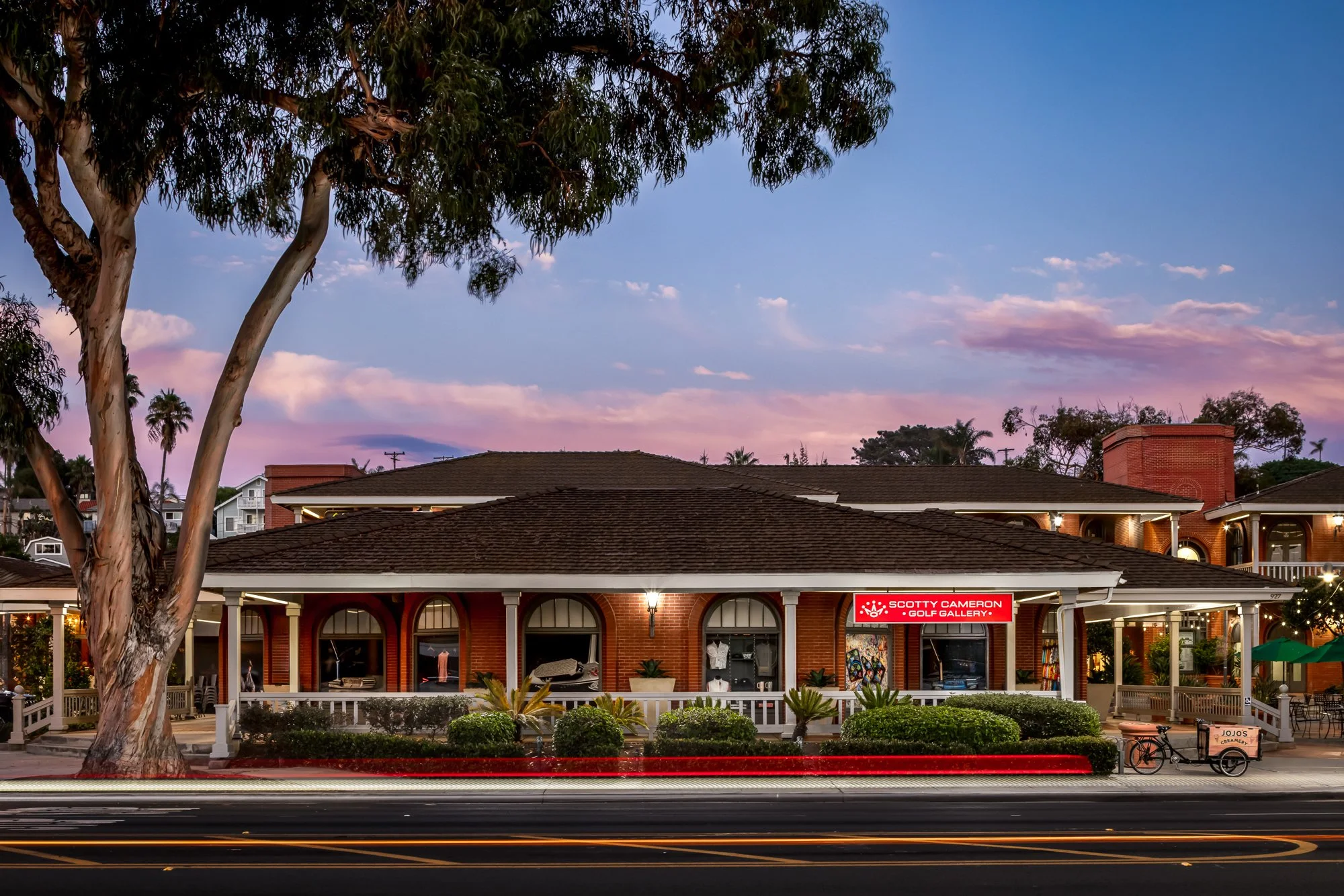Exterior twilight photograph of the Scotty Cameron Gallery with modern architectural lighting and luxury retail design.