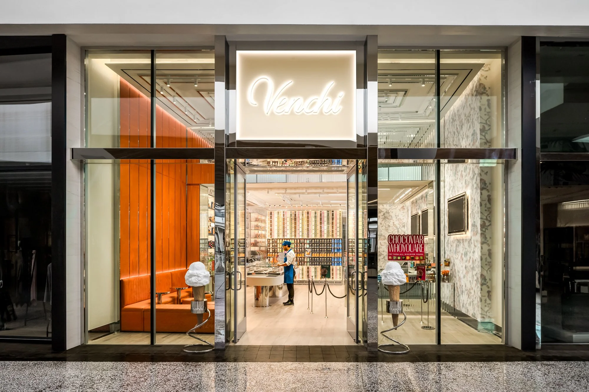 Exterior photograph of the Venchi chocolate and gelato boutique with illuminated storefront and luxury retail design.