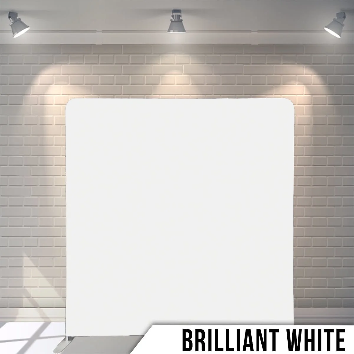 Empty white display board with spotlights on brick wall background and text 'Brilliant White' at the bottom.