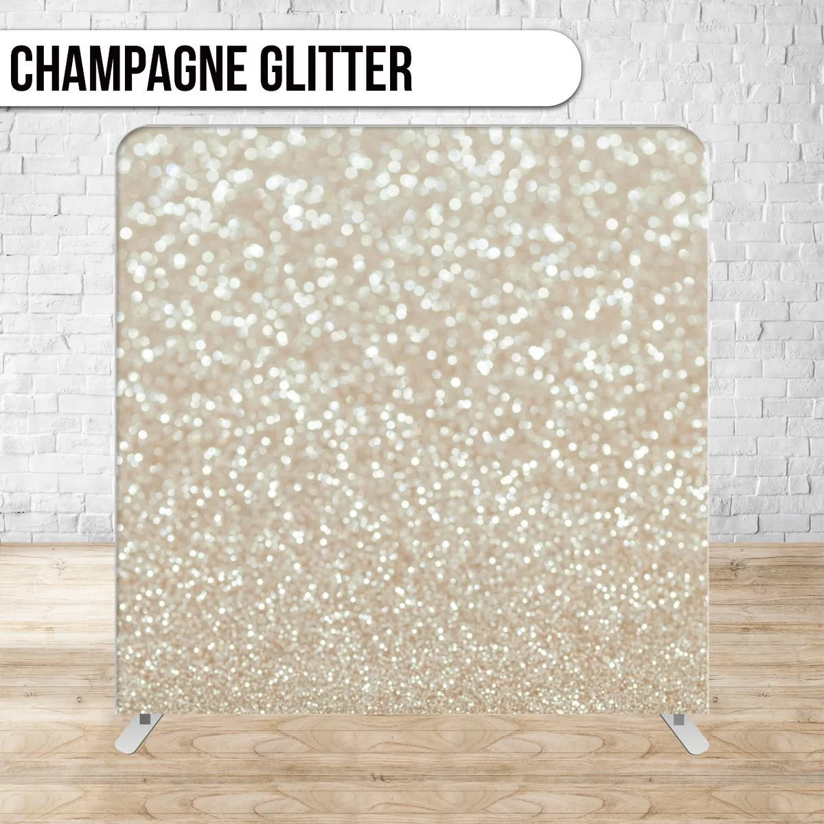 A backdrop with a champagne glitter pattern featuring numerous tiny, shiny, light-colored glitter particles on a flat surface, set against a white brick wall with wood flooring.